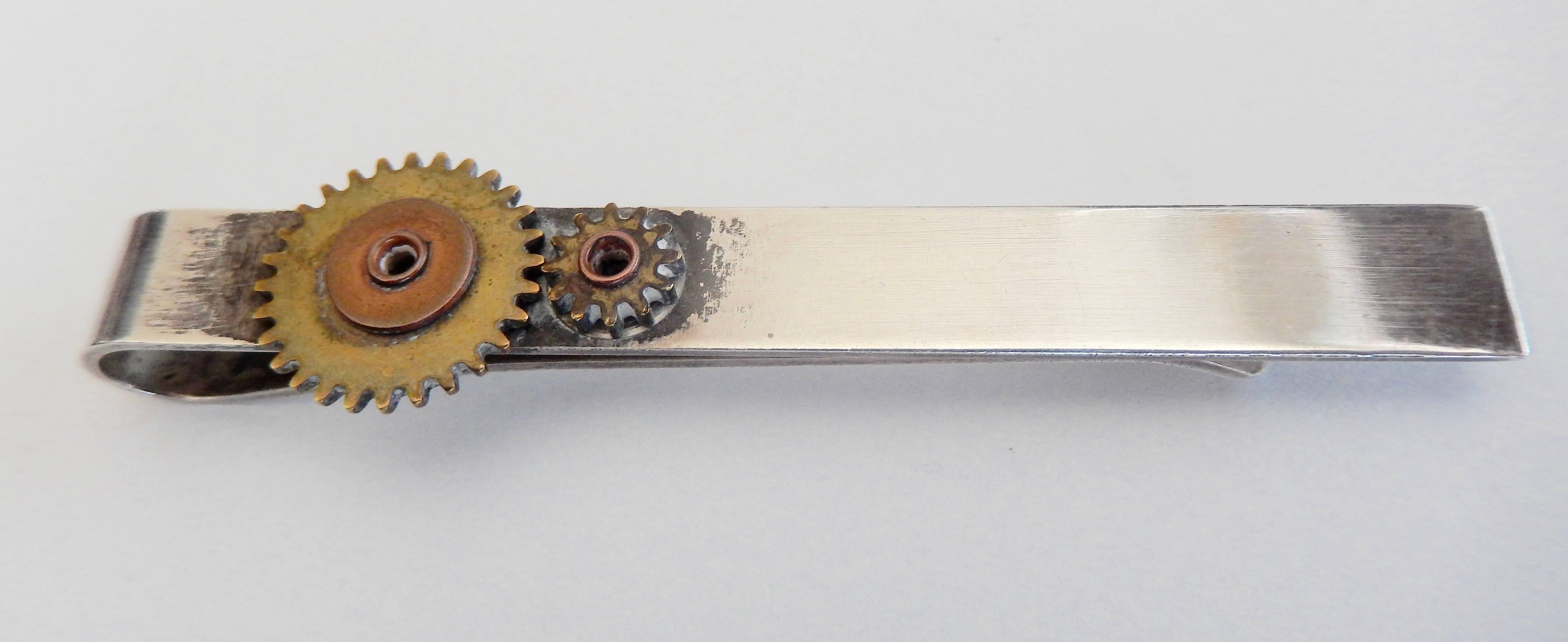 An ingeniously designed tie clip of interlocking gears by the New York artist Francisco Rebajes.  A brilliant example of the Machine Age aesthetic in the decorative arts of the period.  Marked 