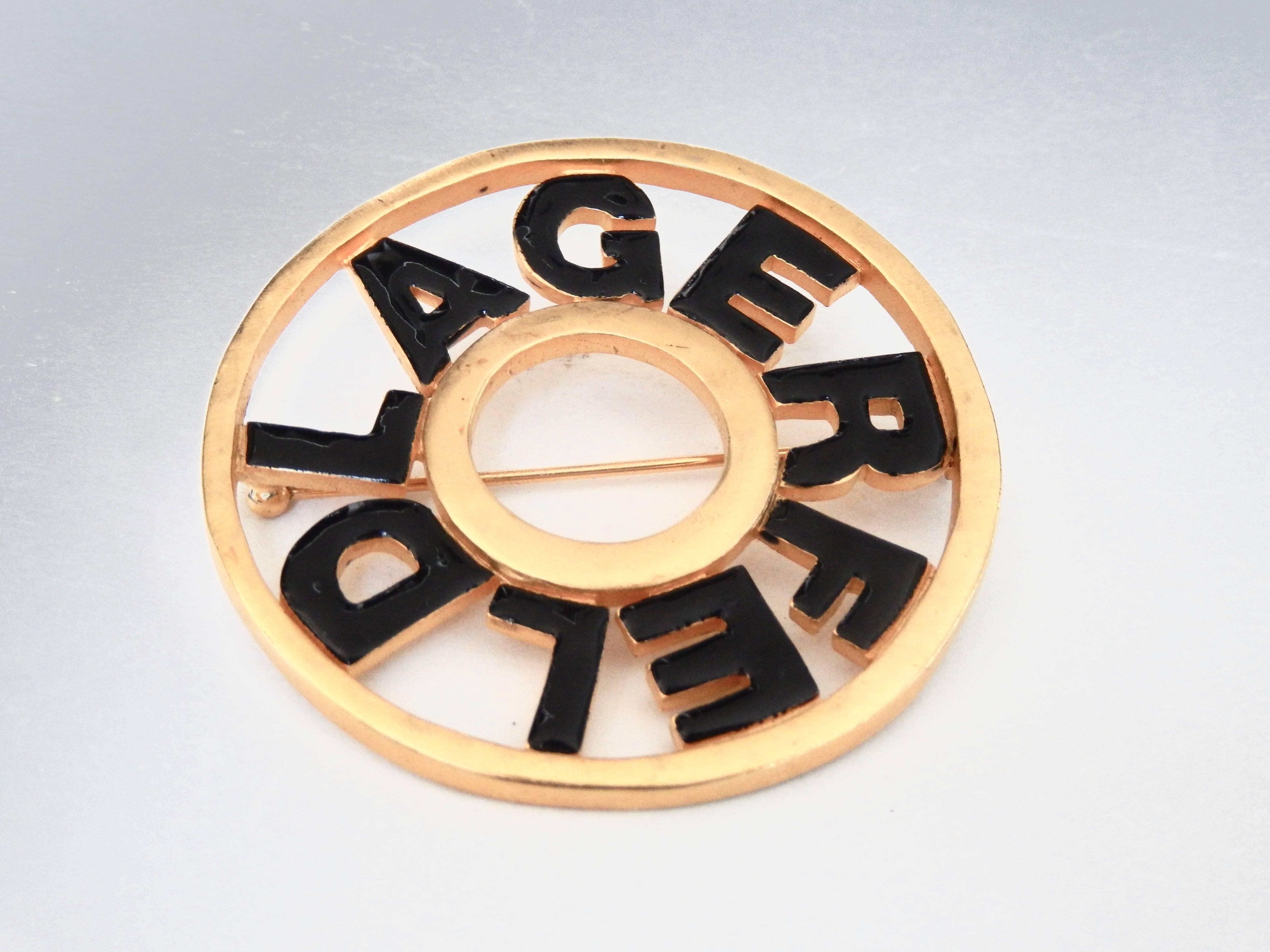 A cleverly designed brooch by Karl Lagerfeld that incorporates his name into the design.  Bold, modern graphic design.  Signed.