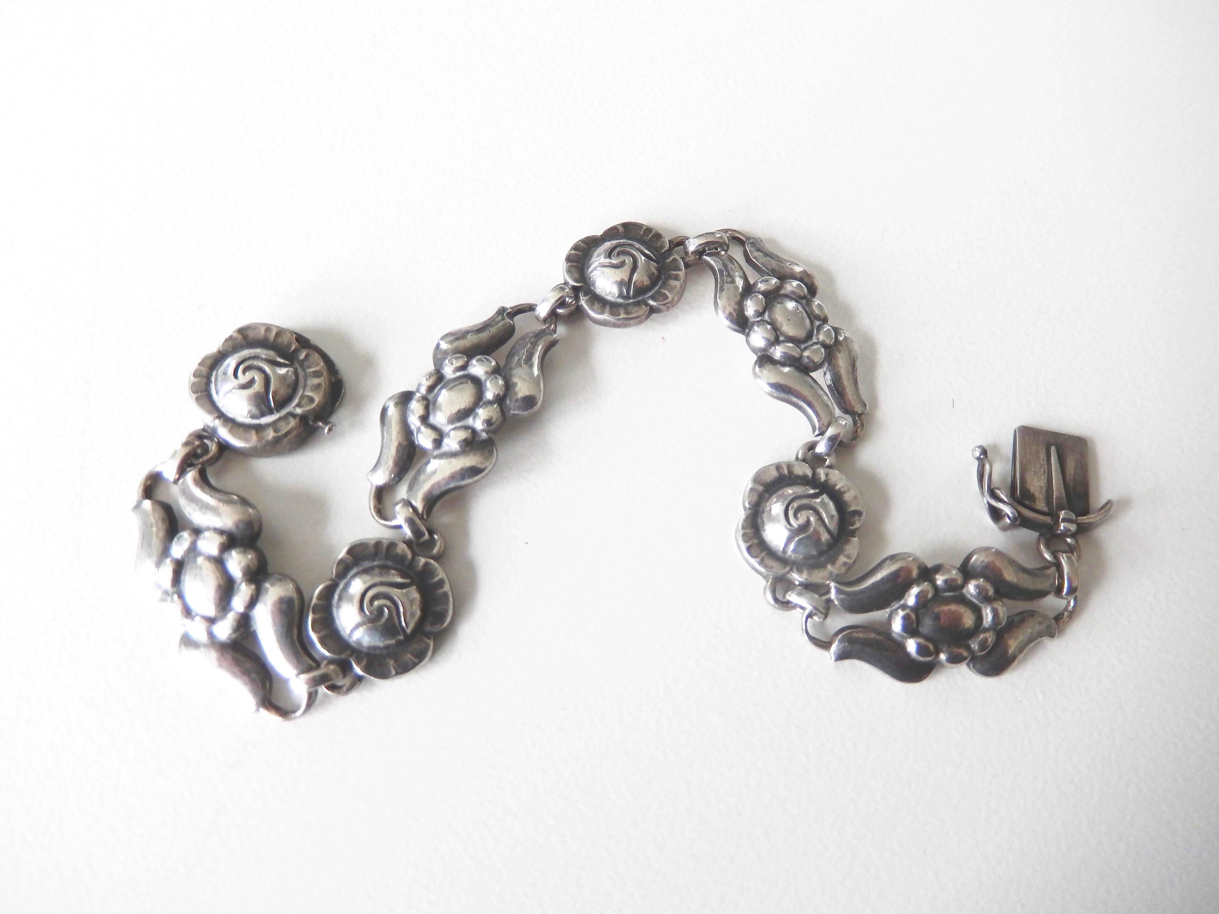 Vintage sterling silver link bracelet by Georg Jensen with stylized rose design.
An intricate, organic design motif.

Reference:  Georg Jensen by Janet Drucker, p. 117.