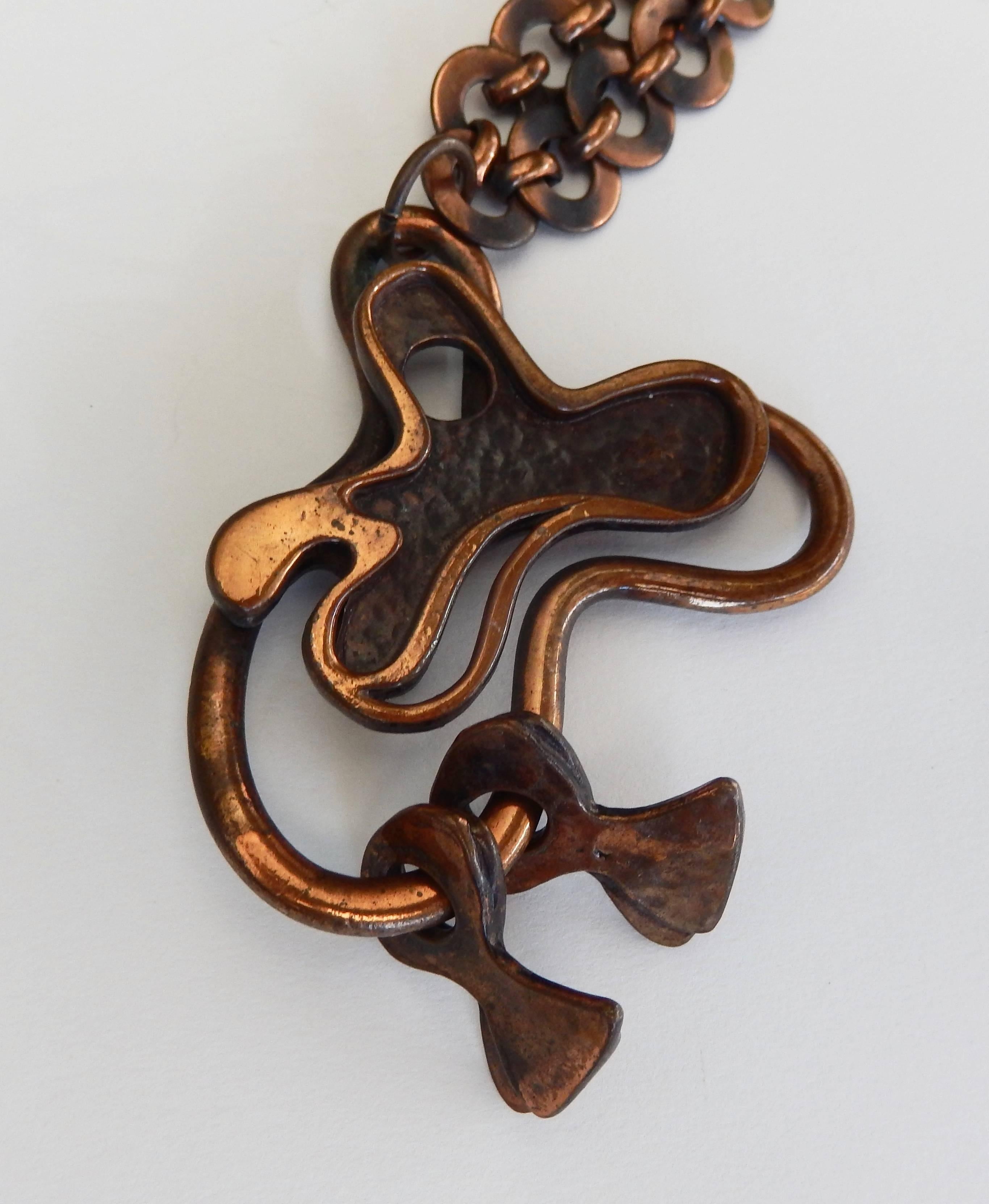 An abstract cast copper pendant with moveable forms by the mid-century modernist Francisco Rebajes (1907-1990). A master craftsman, Rebajes is best known for his innovative metalwork in copper in the 1950s.  The abstract design reflects his interest