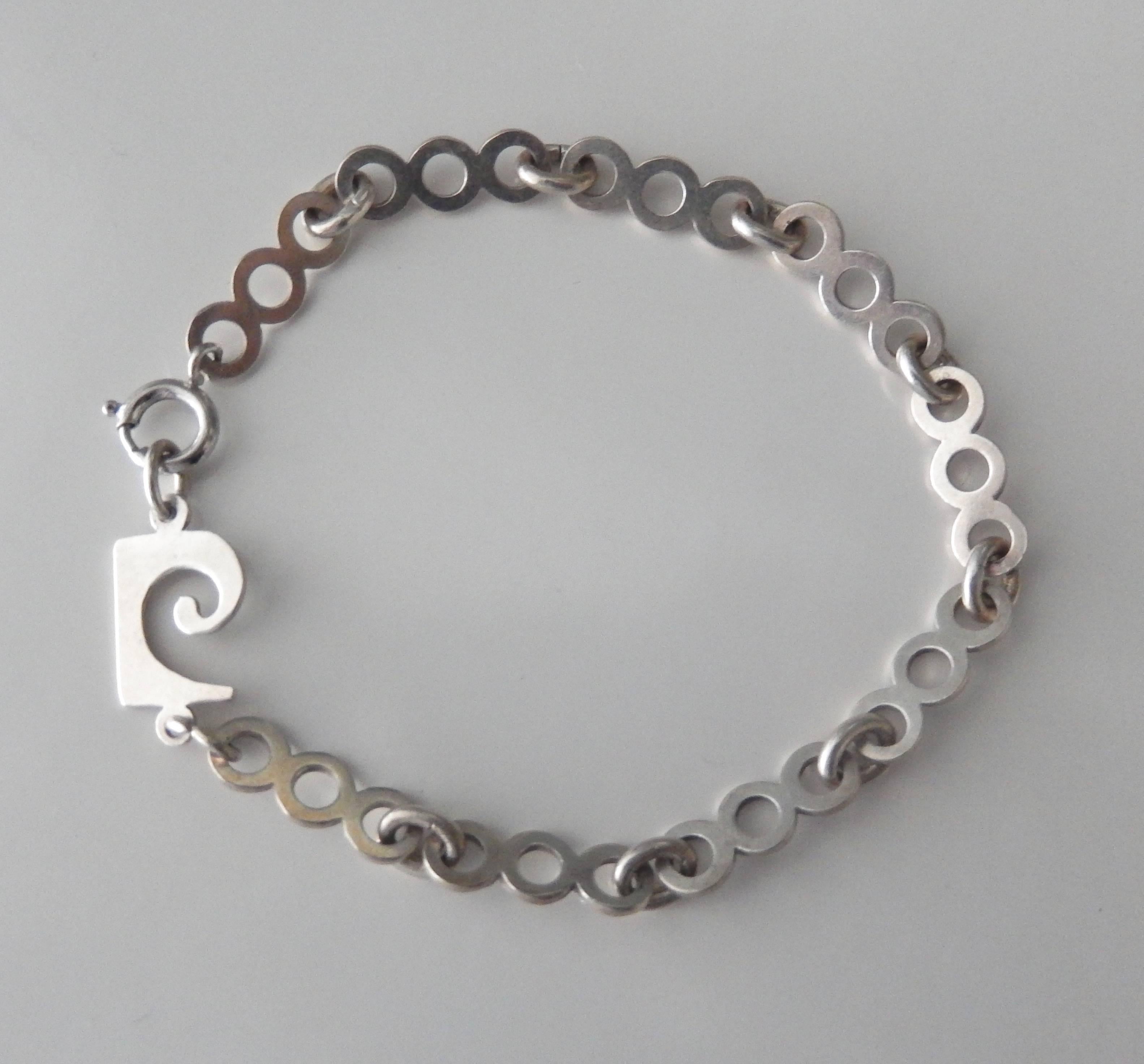 A sterling silver link bracelet by the pioneering modernist Pierre Cardin.  Comprised of geometric links, the bracelet has a minimal, futuristic, 70s design.
Marked: Pierre Cardin  STERLING   Comfortable fit for a small to medium sized wrist.