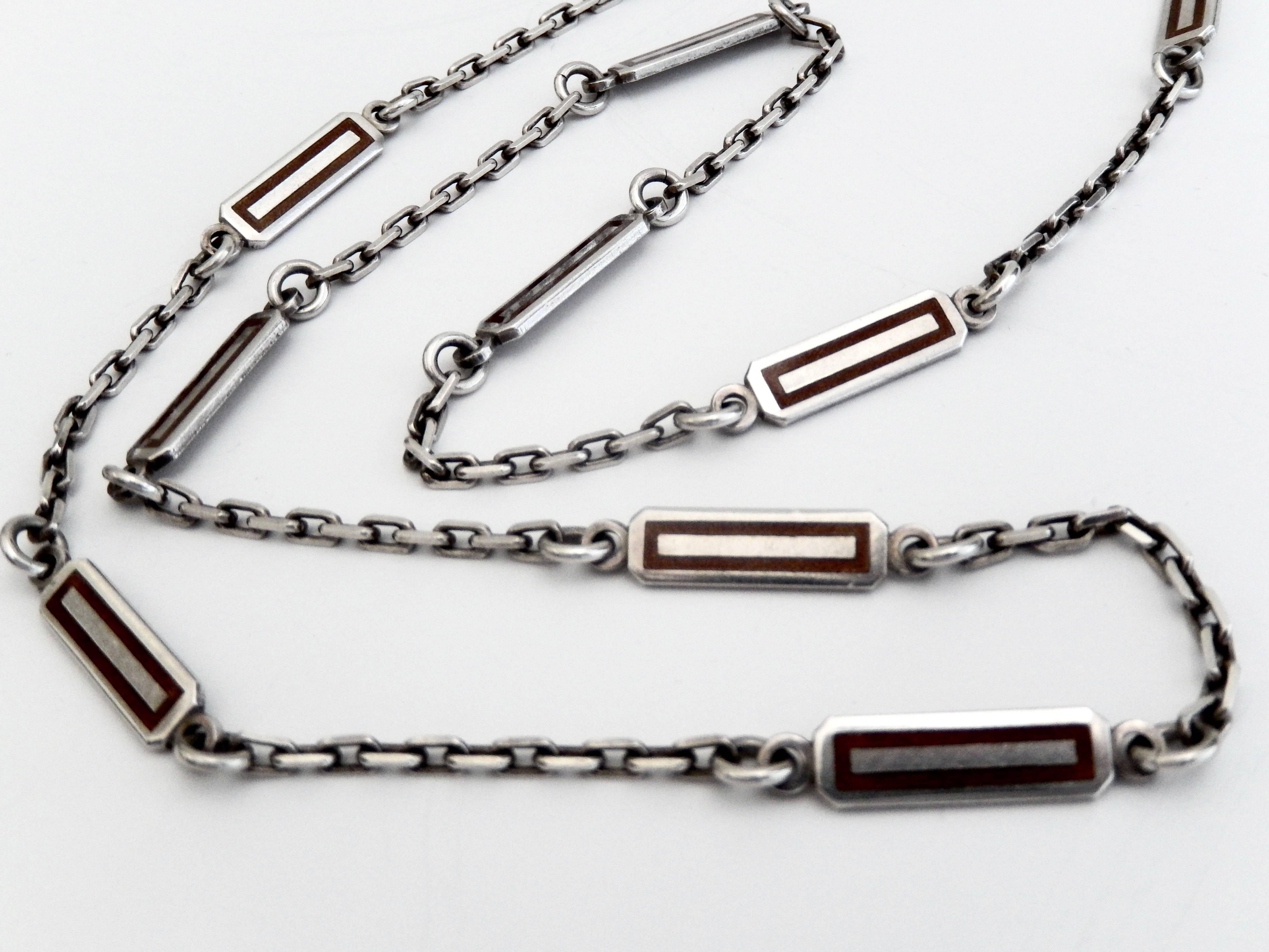 A geometric chain necklace by Gucci.  The rectangular links are highlighted with a chocolate brown enamel. Very cool vintage Seventies Gucci chain.
Marked:  GUCCI  Italy 925 BREV.  No clasp.