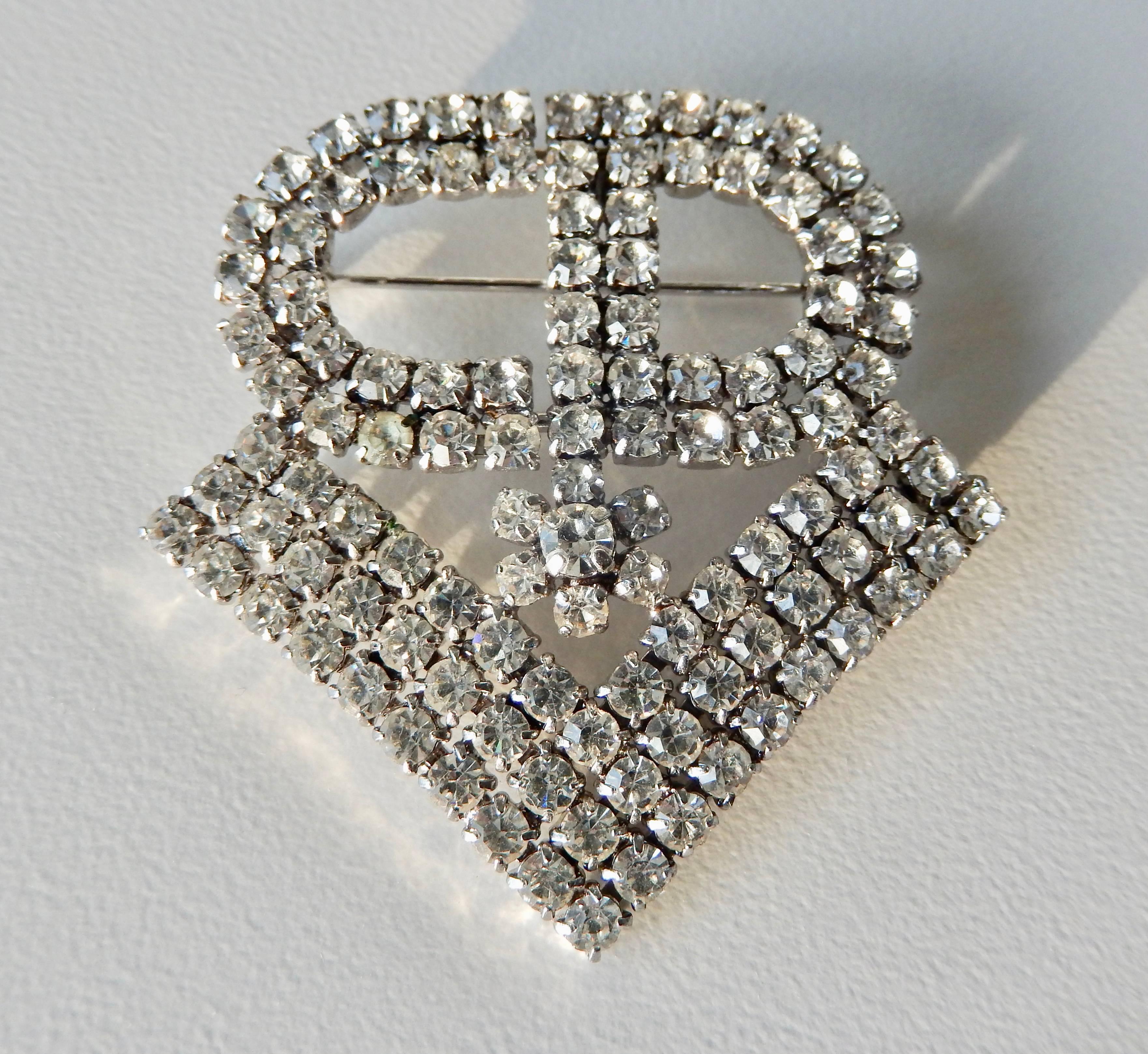 A chic rhinestone brooch by Christian Dior, dated 1971, with an interesting insignia motif.  The initials 
