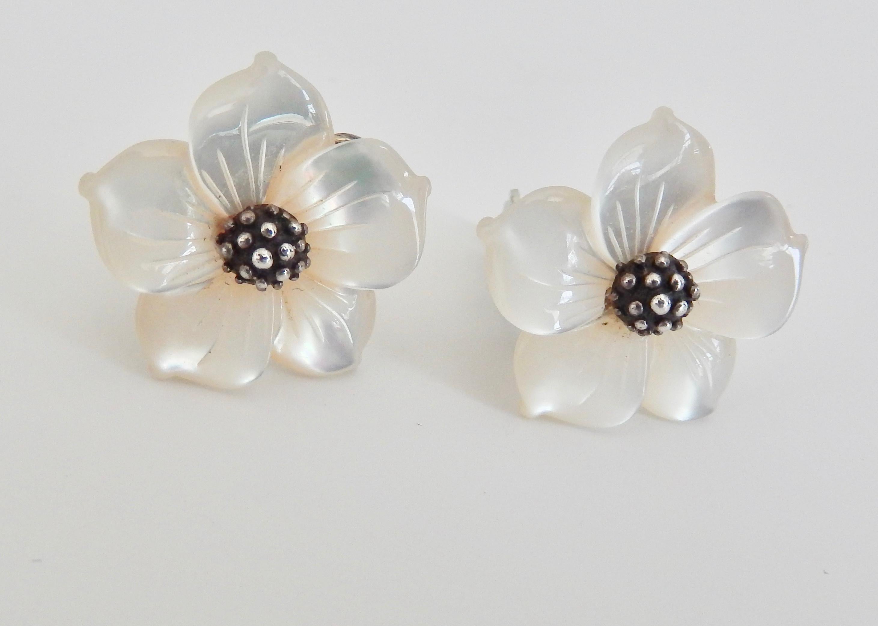 A graceful pair of vintage sterling and carved mother-of-pearl clip-on earrings by the New York designer Stephen Dweck.  Mother-of-pearl is combined with a sterling 