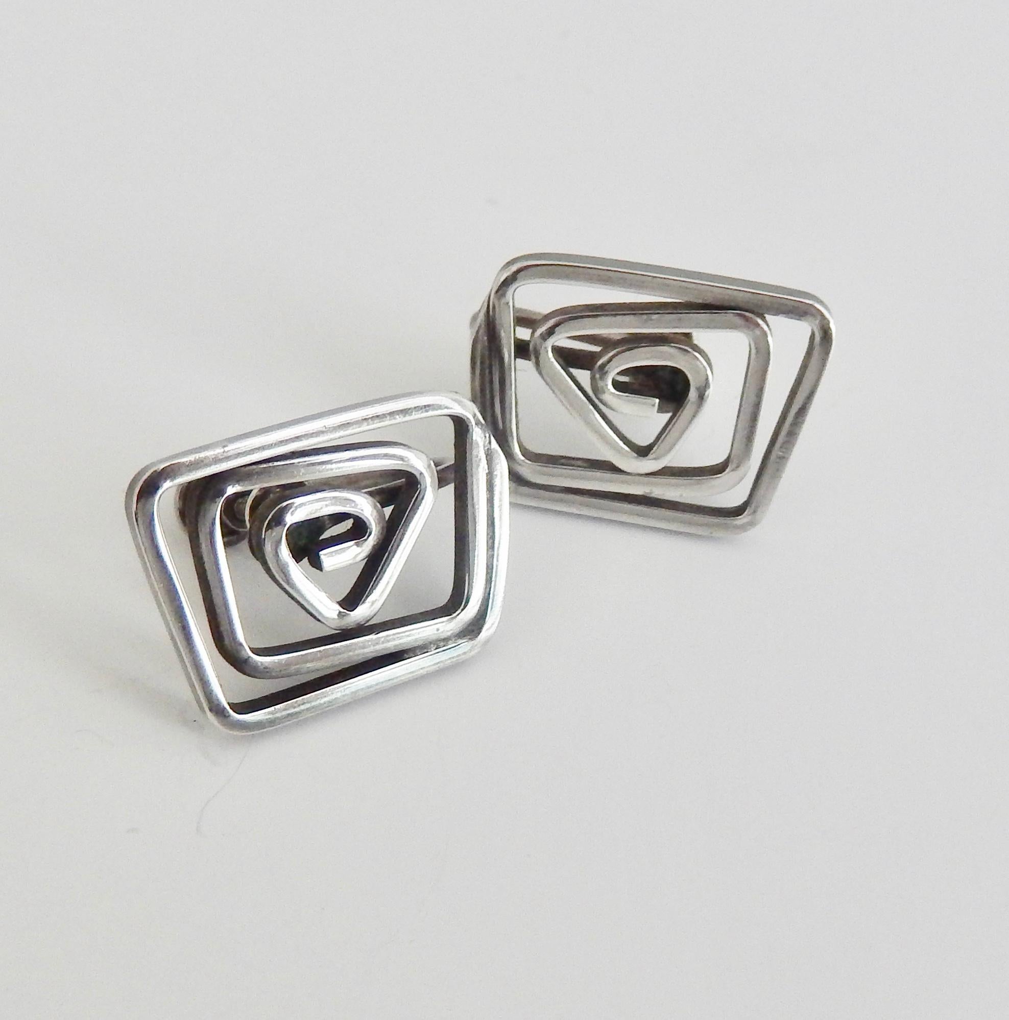 A pair of vintage, screw back, sterling silver earrings with a spiral design by the modernist jeweler Ed Levin.  Known for his skilled workmanship and creative designs, these earrings are a fine example of mid-century American Modernist jewelry.  