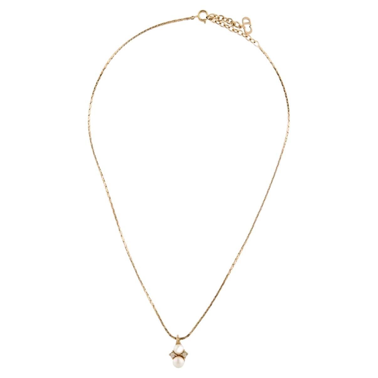 Quintessentially sophisticated, Christian Dior presents this rope chain necklace. Crafted from polished gold-tone metal, the piece is elegantly adorned with faux-pearl and rhinestone embellishments.

Signed at the back. Marked 'Chr.Dior (C) '.

Very