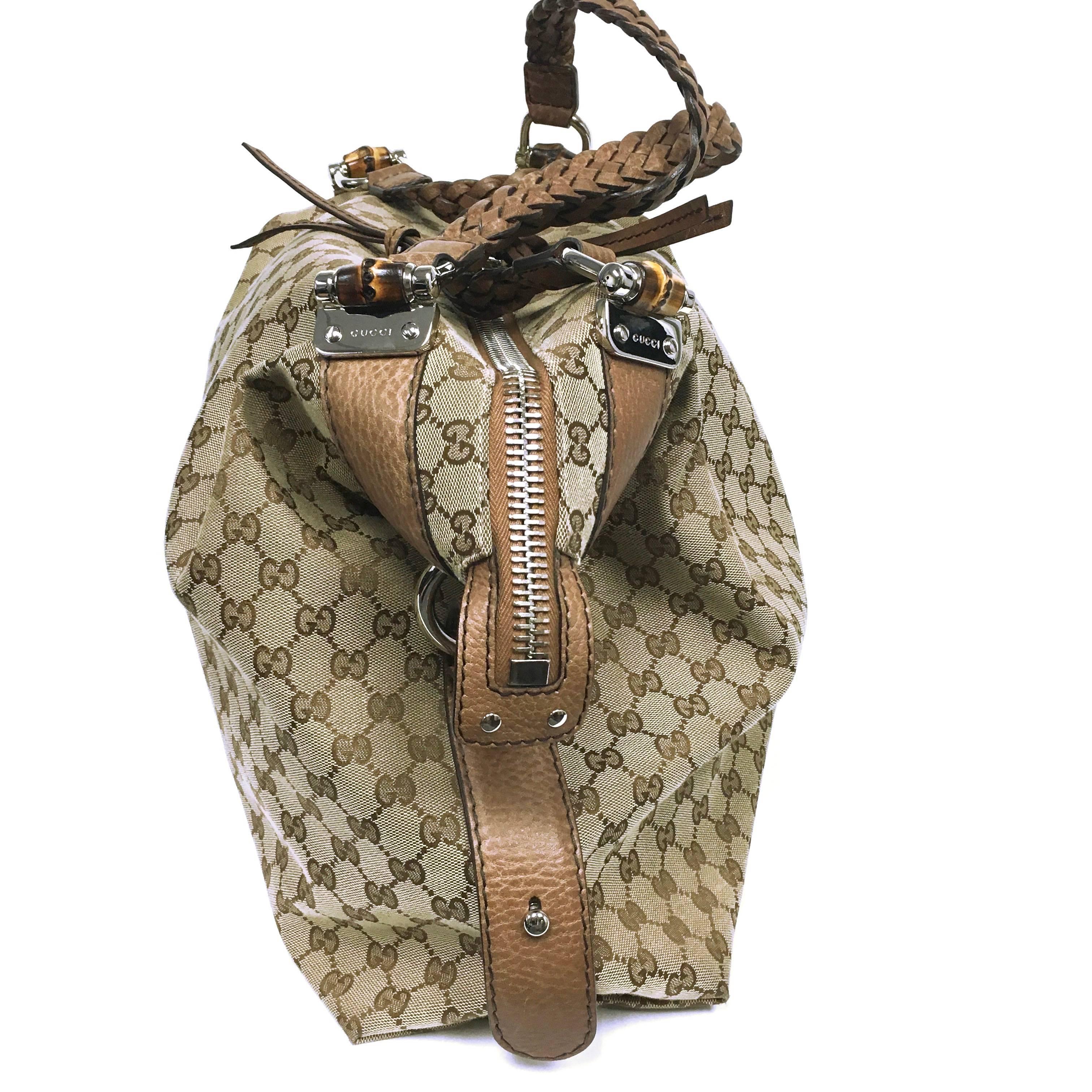 Gucci monogram canvas  with pebbled leather trim. Pebbled leather straps loop at sides with top ring. Zip top closure with long knotted leather pull. 18'' braided shoulder straps with 7'' drop and bamboo detail D-rings. Logo jacquard fabric lined