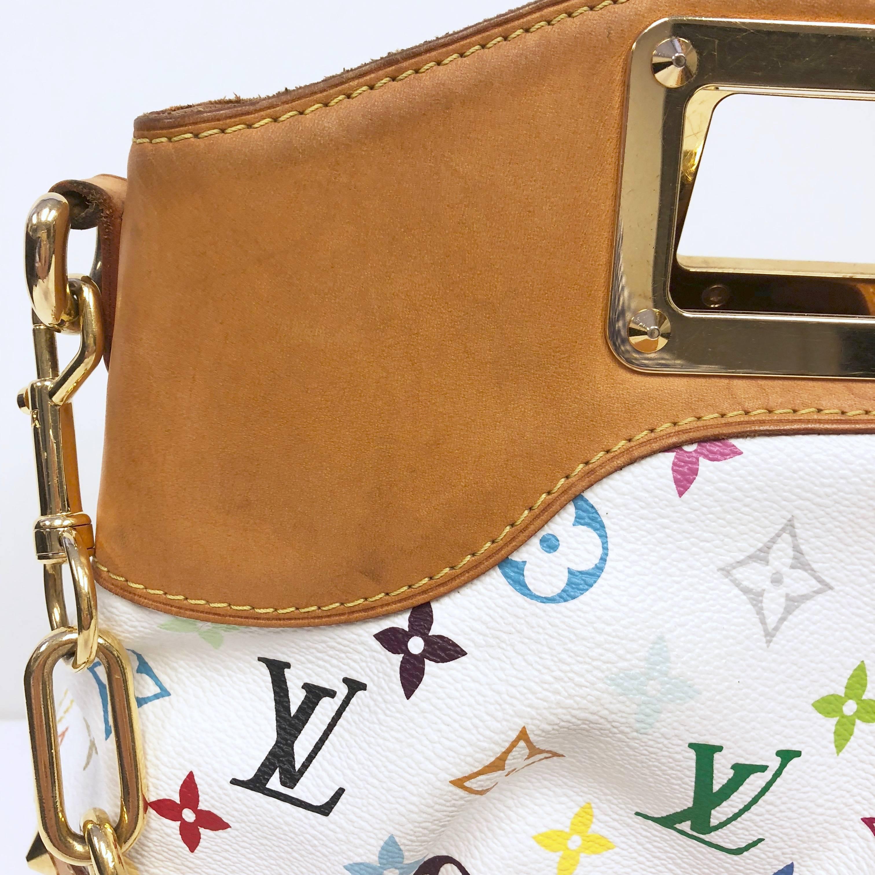 Louis Vuitton Judy MM Bag featuring Takashi Murakami's popular white monogram multicolor print. Stunning handbag with a twist of style and fun. Accented with vachetta leather details and polished gold-tone hardware. Feminine design with an inset