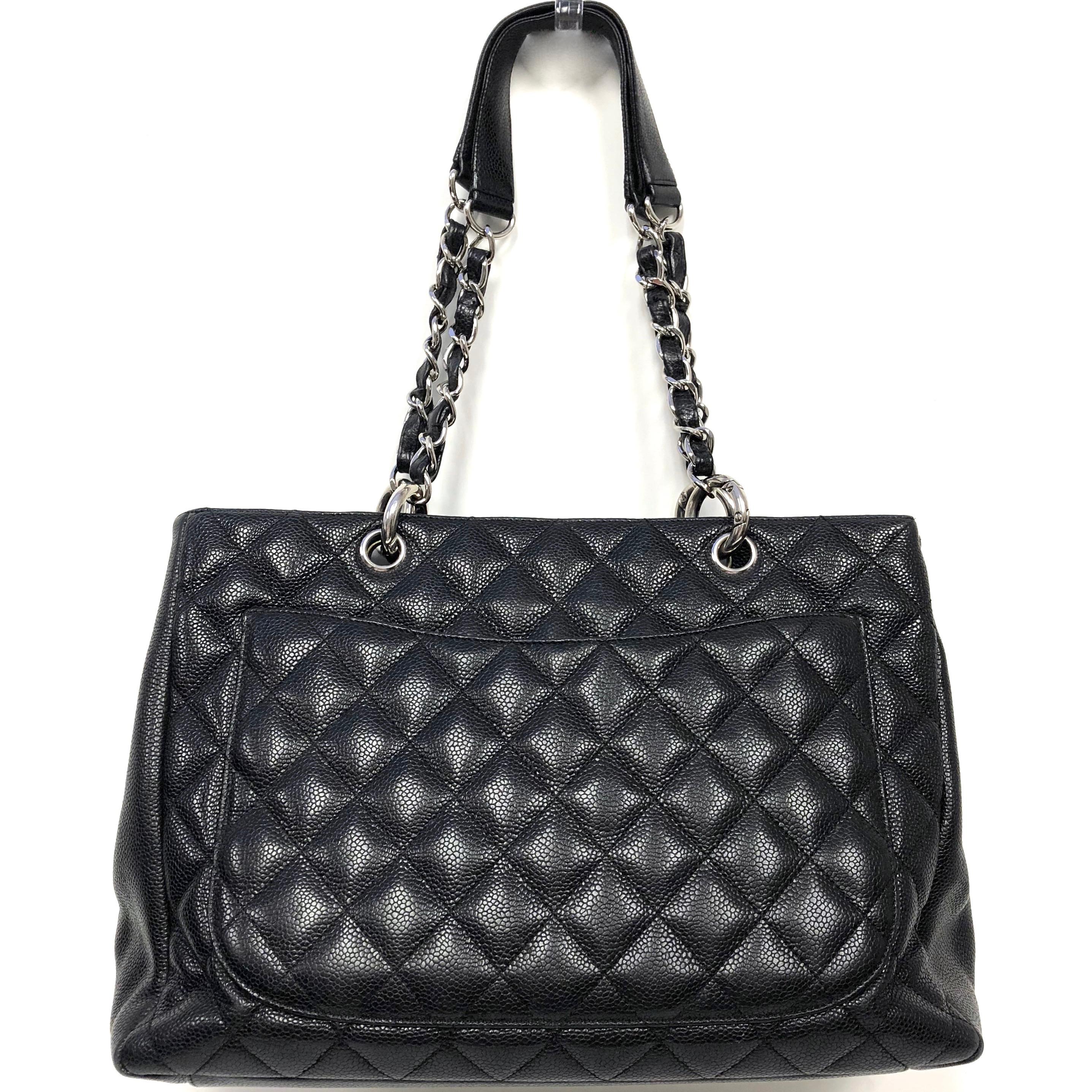 Chanel quilted Grand Shopping Tote GST, crafted in diamond-quilted caviar leather in black. The bag features leather-threaded polished silver chain link shoulder straps with leather shoulder pads, a prominent quilted Chanel CC logo on the front, and