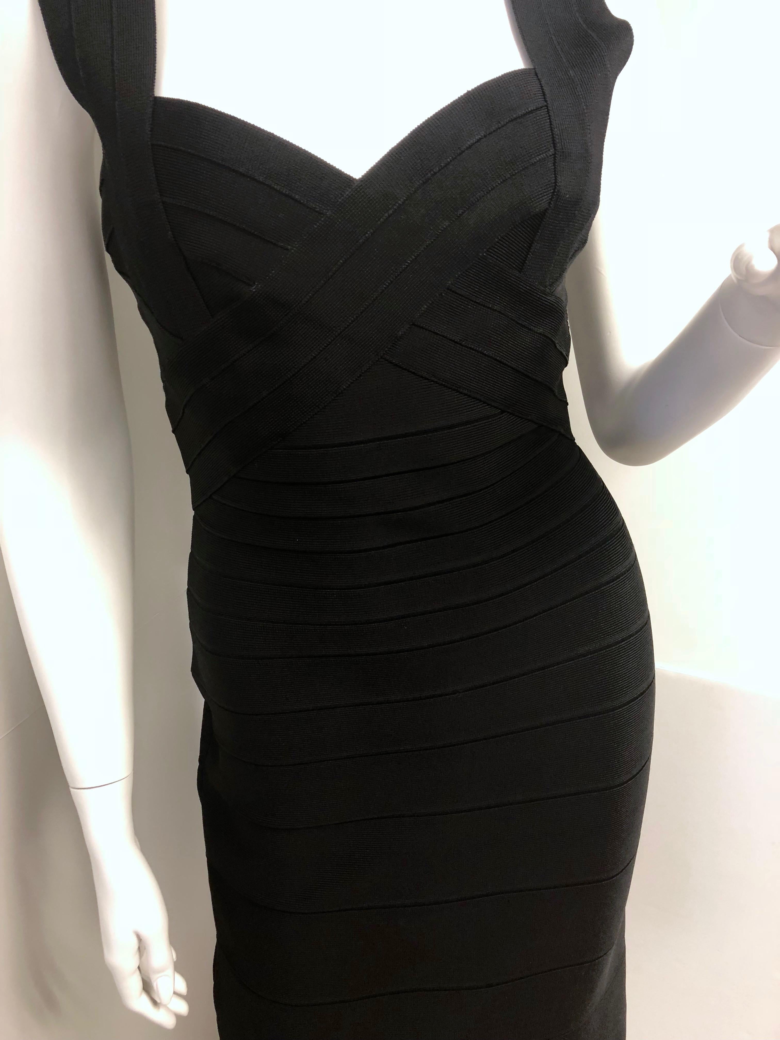 Herve Leger by Max Azaria black V neck and back bandage dress for a form fitting silhouette. Sleeveless dress with back zipper and hook and eye with tonal stitching. Hem is slightly above the knee. This dress is not lined. Composition: Rayon, Nylon,