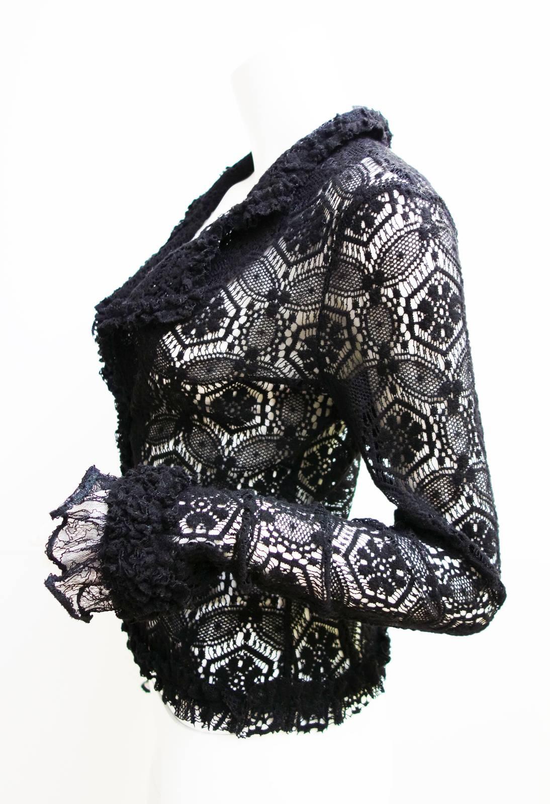 Black lace crochet Chanel cardigan with ruffle trim and hook and eye closure at front. 
Gorgeous piece to wear all year around, dressy or casual.
Size: 38 Made in Italy
Style# P24766W03444
Composition: 80% Wool, 20% Nylon