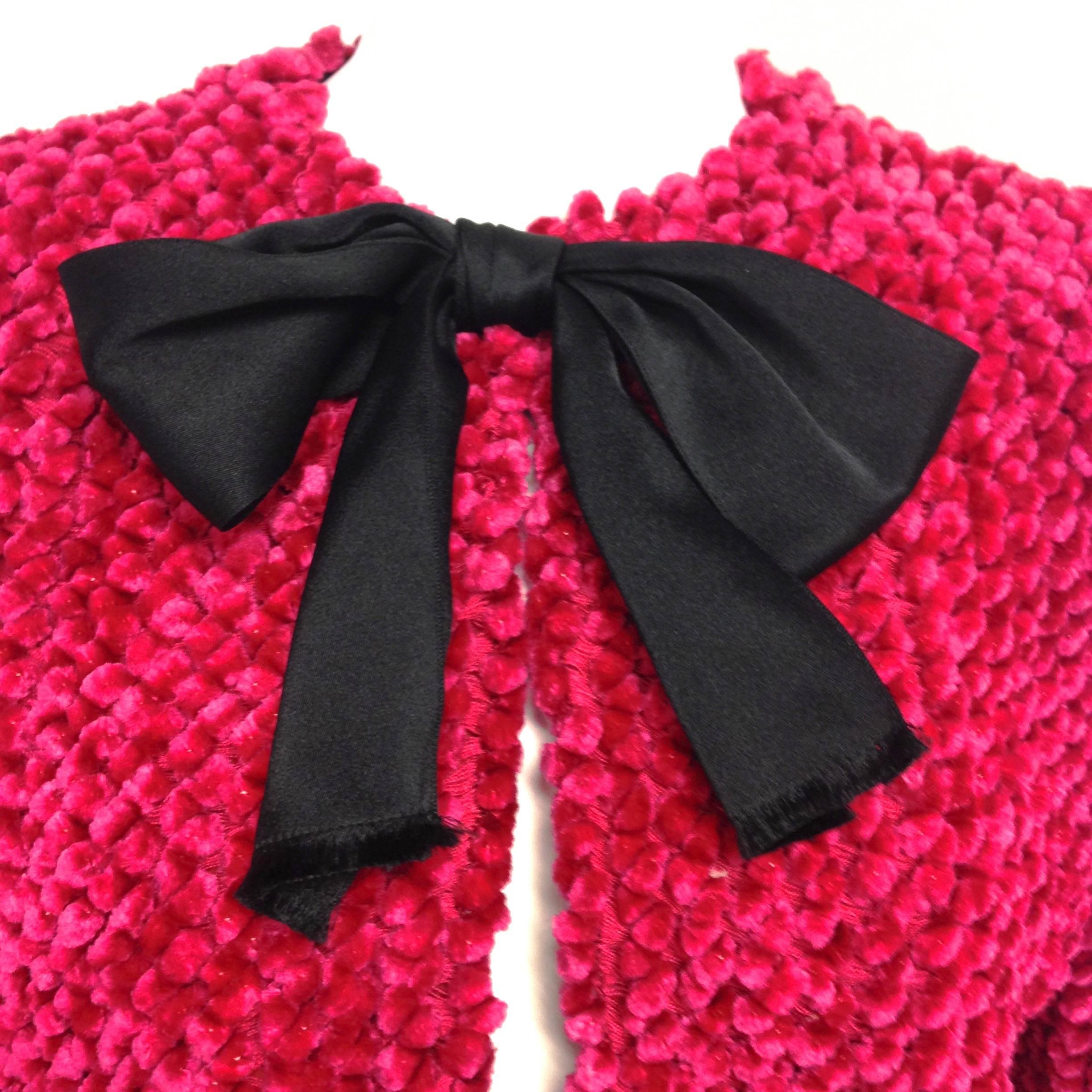 Amazing vintage Bill Blass red evening jacket with black satin bows and mink fur trim accents. Just perfect for the holiday season. 
Front hook and eye closures (top, middle and bottom)
The satin ribbons and fur trims are three inches wide. Fully