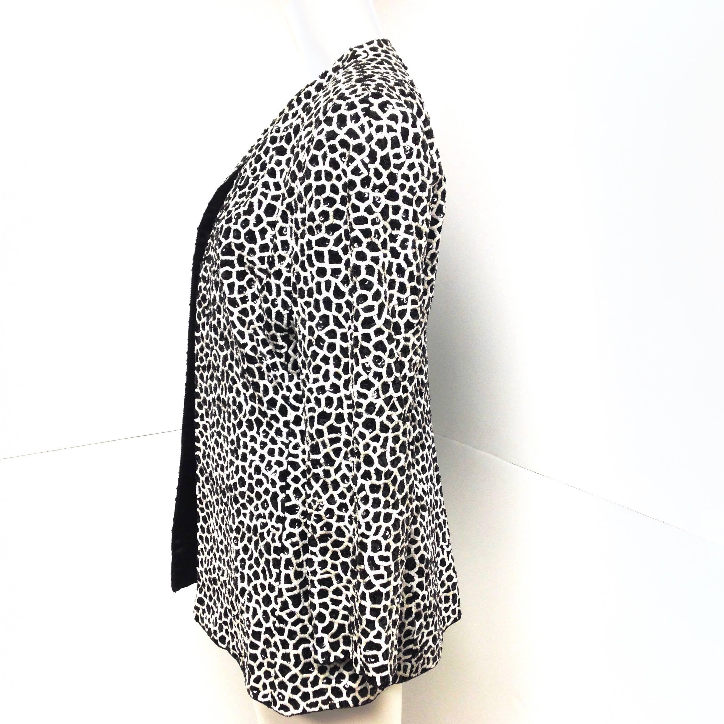Amazing Bill Blass black and white sequined jacket from the 1980s. 
It is entirely covered with small black and iridescent white sequins, edges trimmed with black beads, open front.
 It is tagged size 12, made in the USA with the union label. I