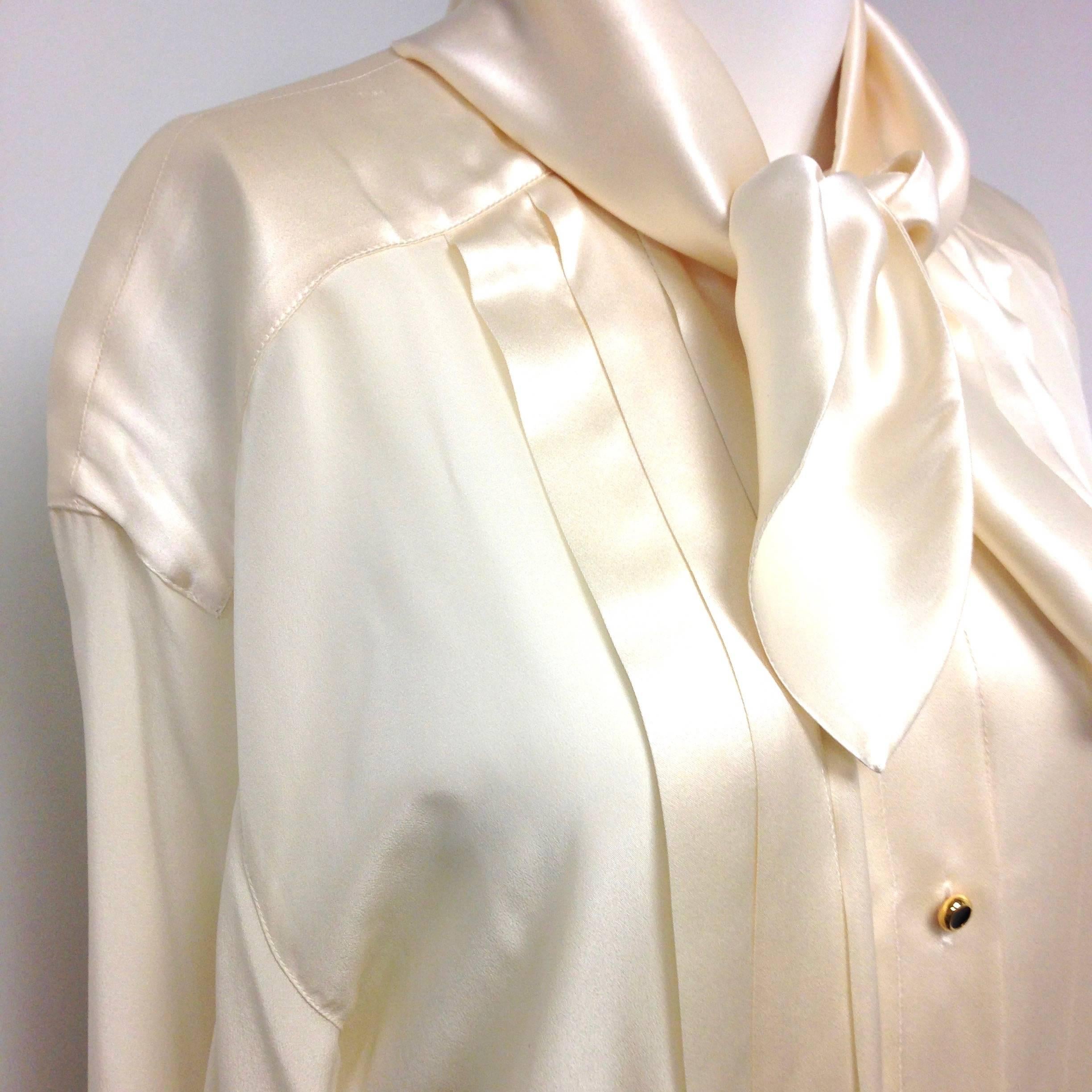 Classy vintage Escada silk blouse by Margaretha Ley. Pleated front, scarf collar, line of buttons and bishop sleeves. Beautiful and elegand cream color. Made in Italy. Period: 1980s  Material: Silk  Condition: Excellent  Size: 42  
Measurements