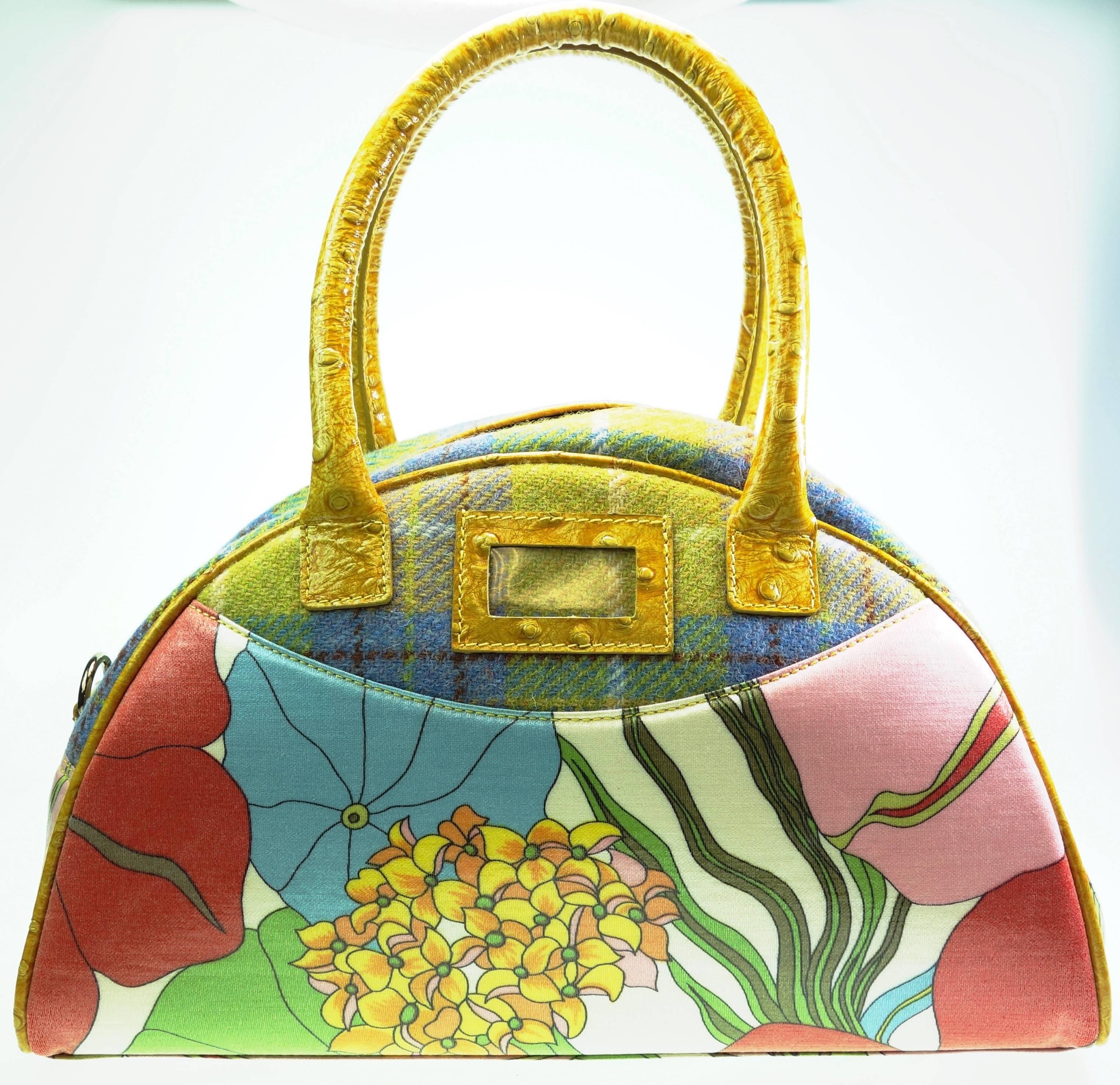 Colorful handbag from John Galliano. The composition of differnet materials and colors makes it very unique. The lower part of the bag is coated canvas, the top is tweed fabric. The handles and the removable strap is made of embossed lether with