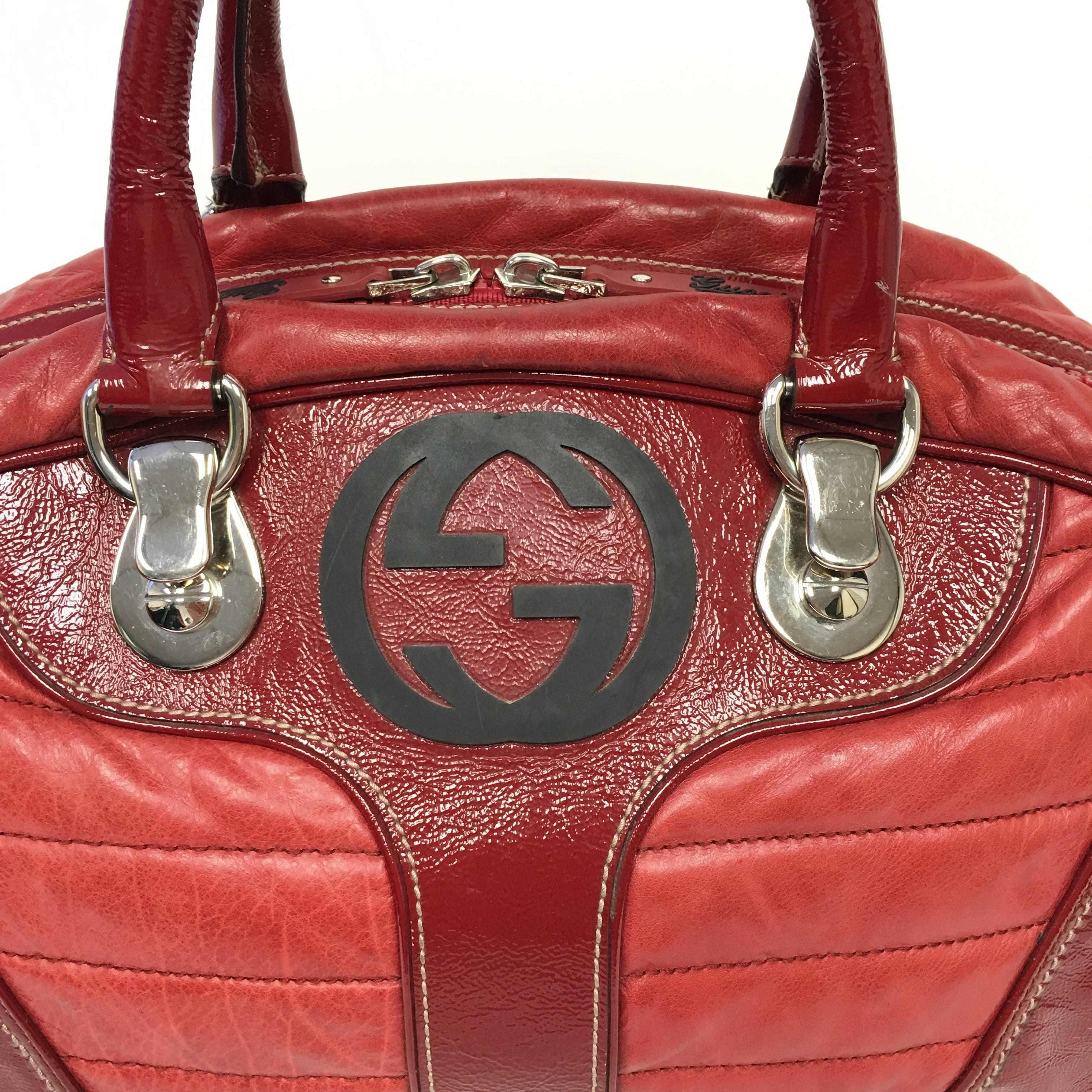 Hard to find red patent and soft quilted leather Gucci Snow Glam bag with silver-tone hardware, red leather trim,  stitching throughout, GG logo at front face, woven lining, single interior zip pocket, dual interior patch pockets and top zip