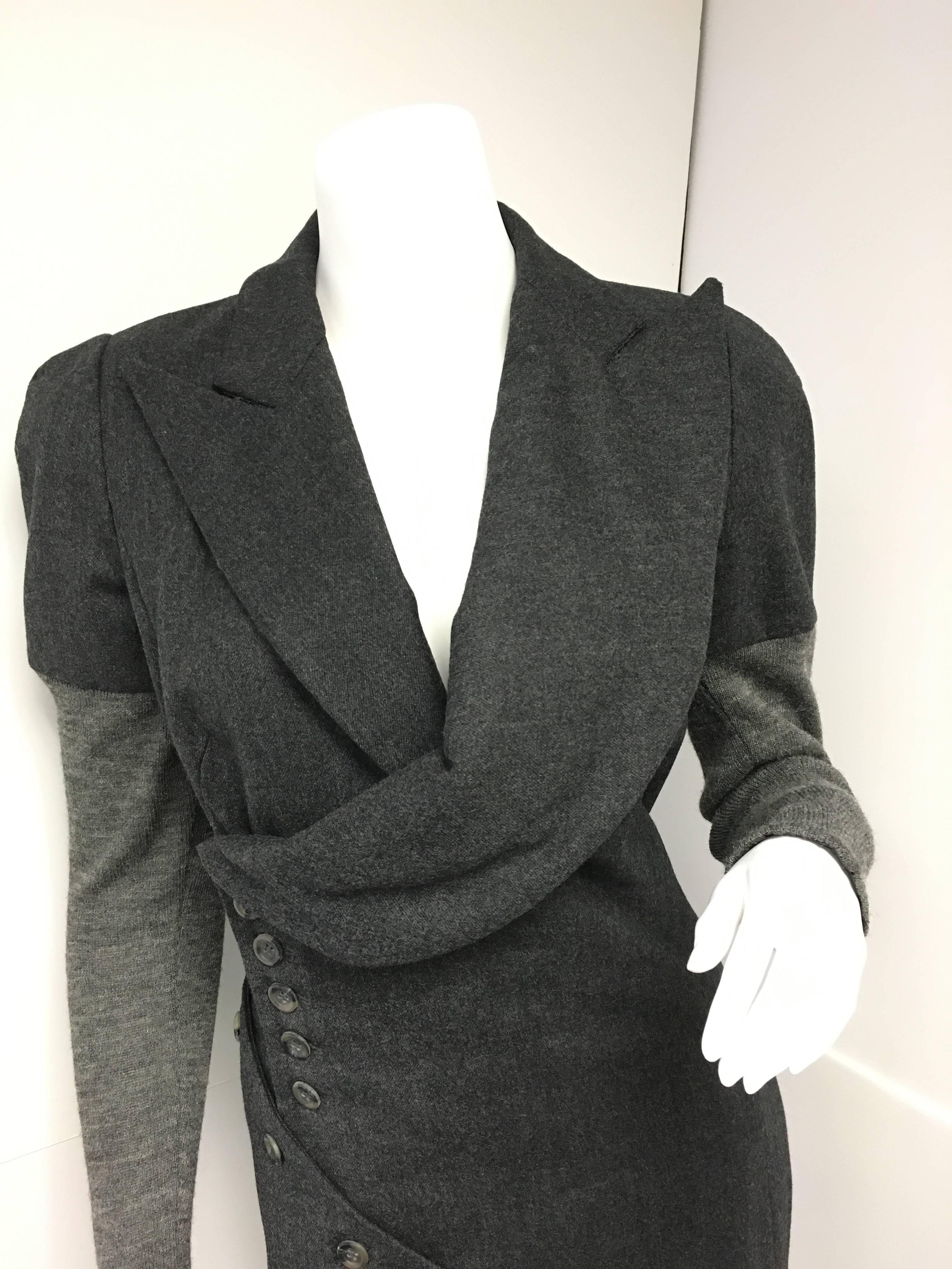 Amazing early Alexander McQueen gray wool fitted dress with knit sleeves.  
A-symmetrical neckline with button closures begin under the right arm and circle around the body all the way down to the hemline. These buttons are working. Fully lined.
