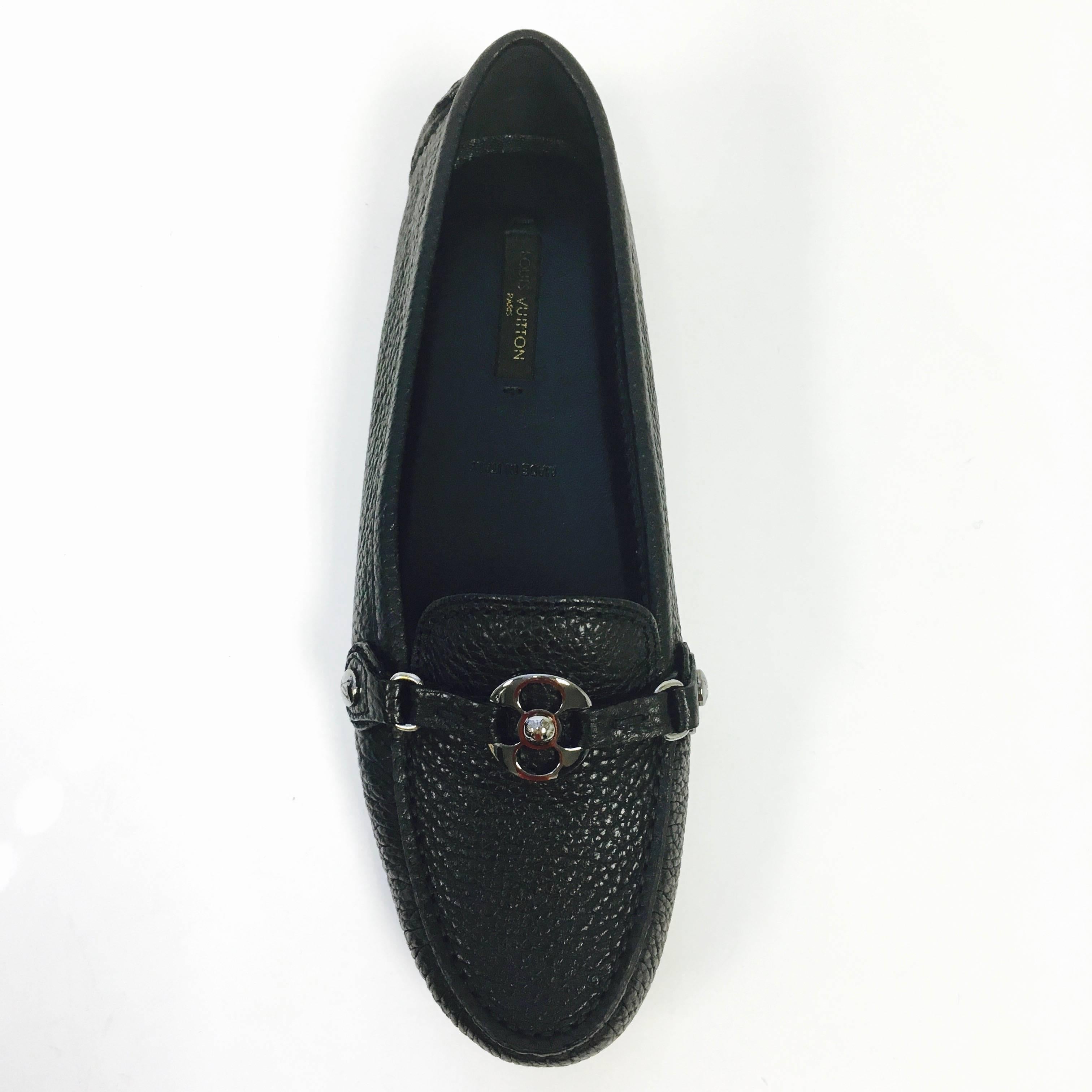 Elegant and simple, these stylish loafers are versatile and comfortable in grained calf leather with bright golden LV rivets and a large Monogram flower accessory. These mocassins have a rubber-dotted sole and padded leather insole for enhanced