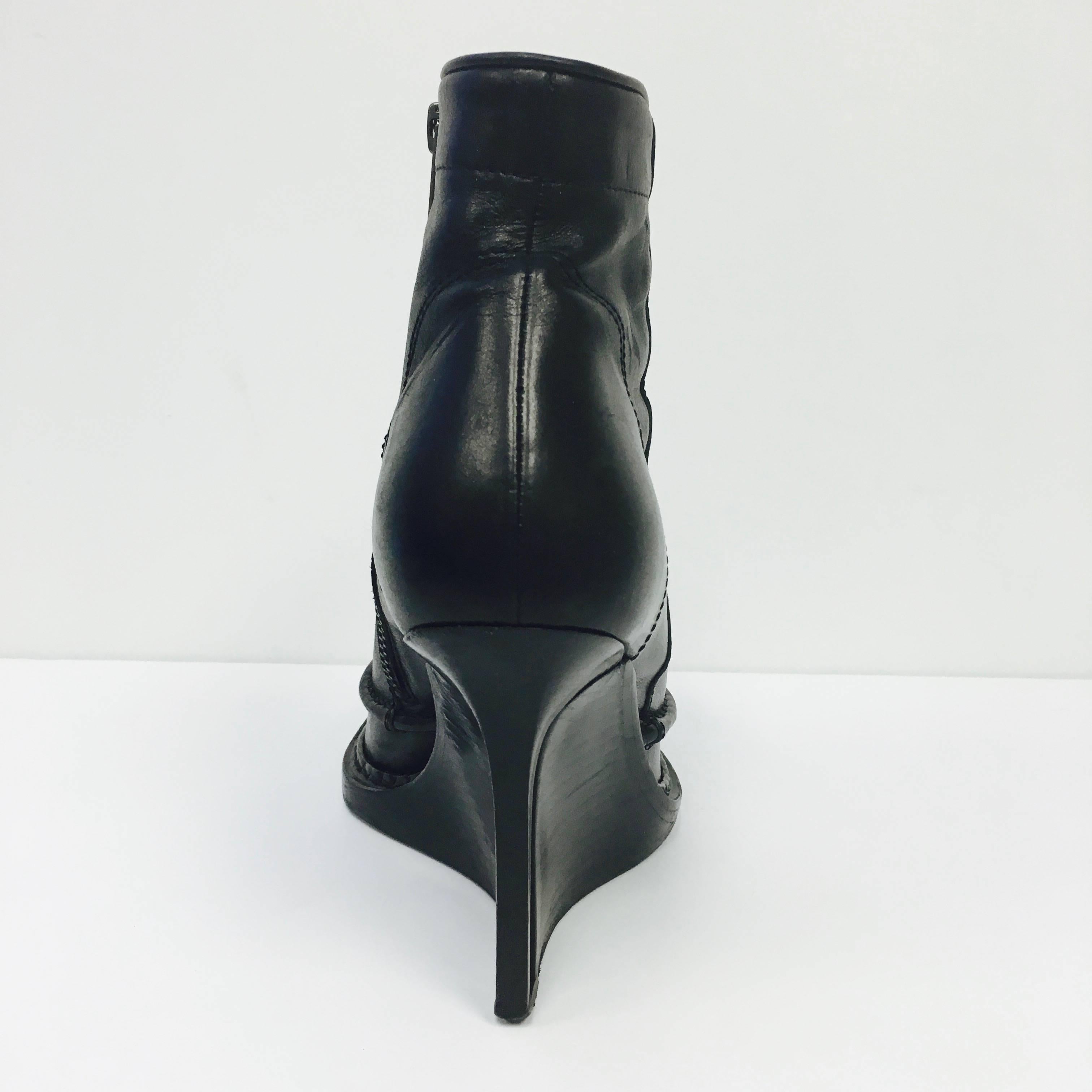 Ann Demeulemeester Women's Black Wedge Ankle Boot 38
Size: 38 ITA / 8 US
Made in Italy
 
Platform shoe with wood wedge heel.
Black leather with stitched details. 
Excellent pre-owned, shows some wear on the bottom soles.
In original box,
