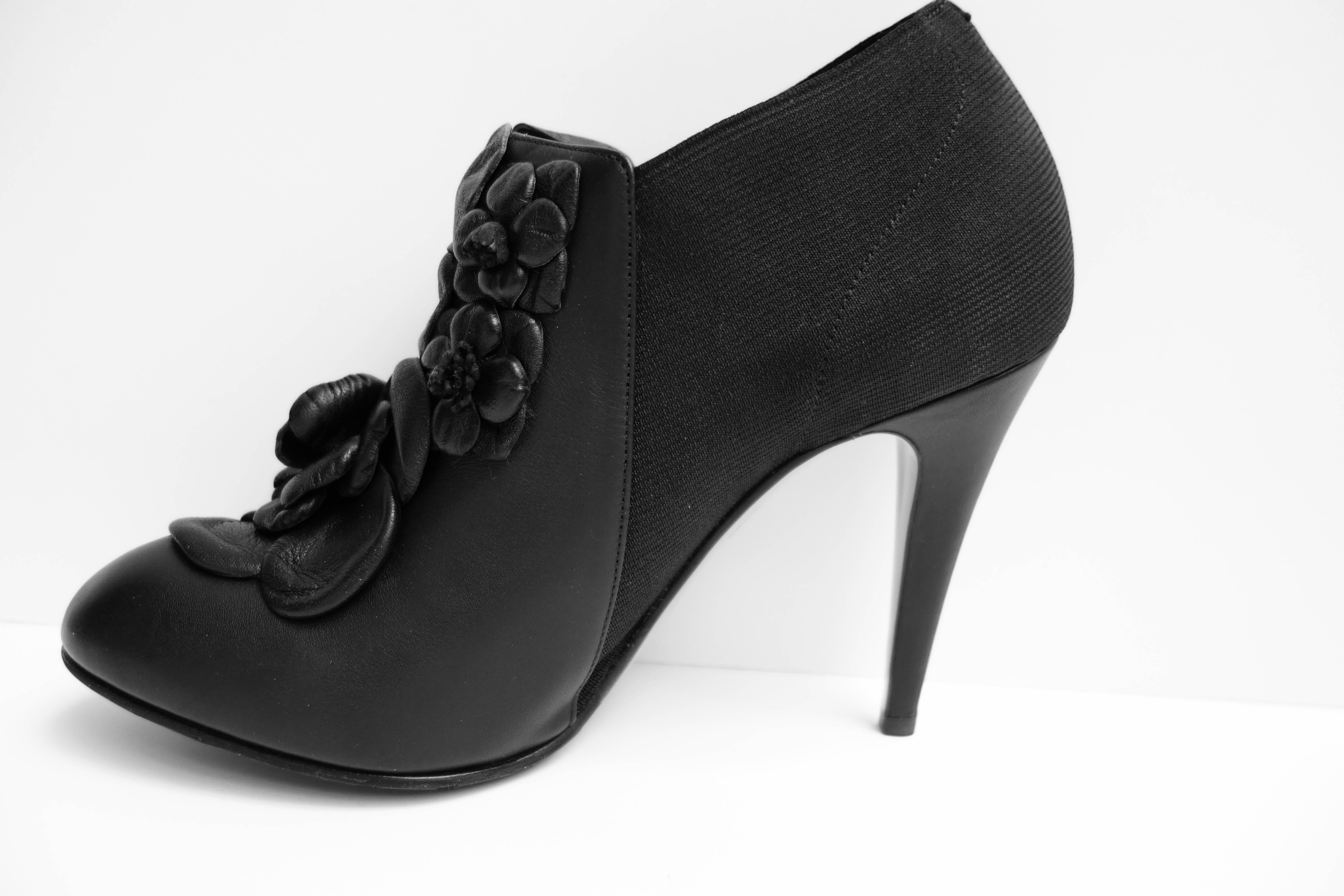 Authentic Valentino Techno Couture Bootie Shoes
Size 39.5 ITA / 9.5 US
Retail: $1,145.00 Sold Out

A distinctively Valentino bouquet of leather roses blossoms on the front of this well-fitting stretch bootie. Intricately detailed,