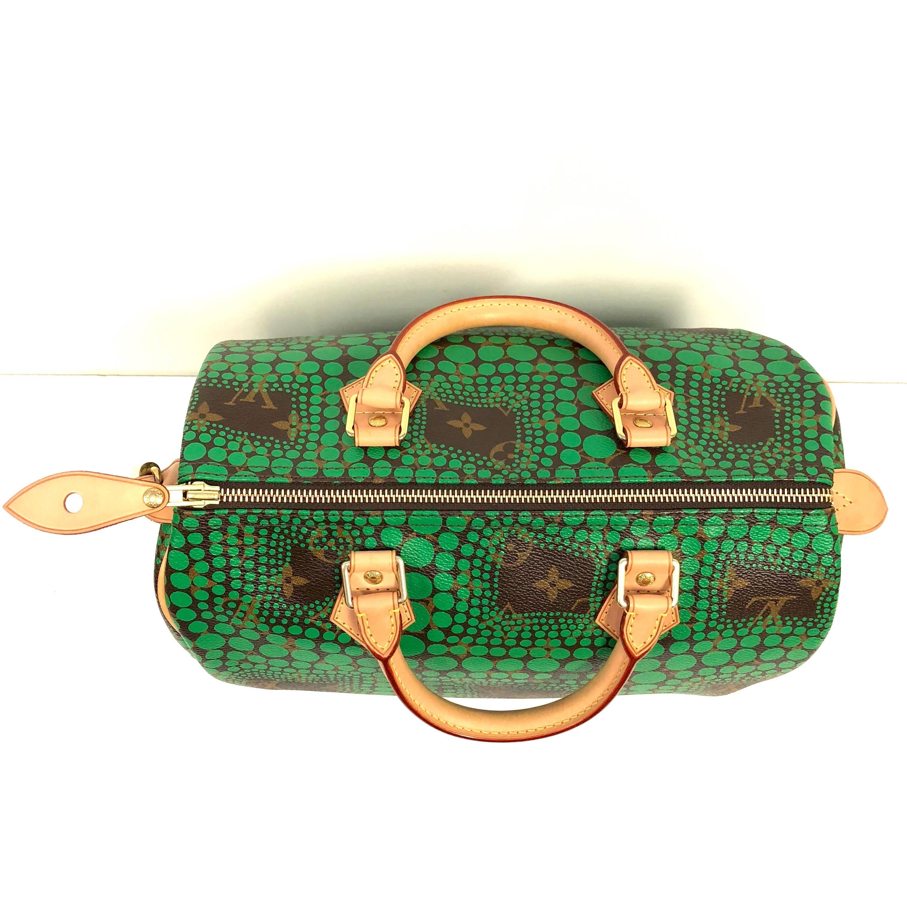 Louis Vuitton Limited Edition Speedy 30 bag  bright green dotted Op Art graphic pattern from artist Yayoi Kusama printed on Louis Vuitton monogram canvas. The bag features vachetta cowhide rolled leather top handles and trim with brass hardware. The