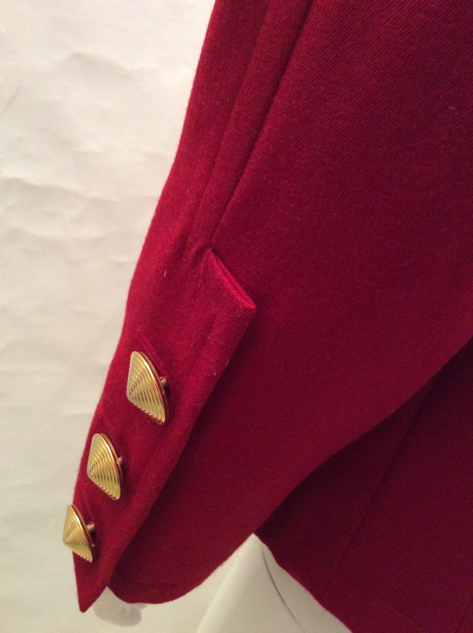 This Yves Saint Laurent Variations fabulous blazer has the most amazing 6 gold tone circular buttons down the front and 3 buttons on each cuff. The blazer has two front pockets and one top left pocket. There is no size listed. My guess is, it is