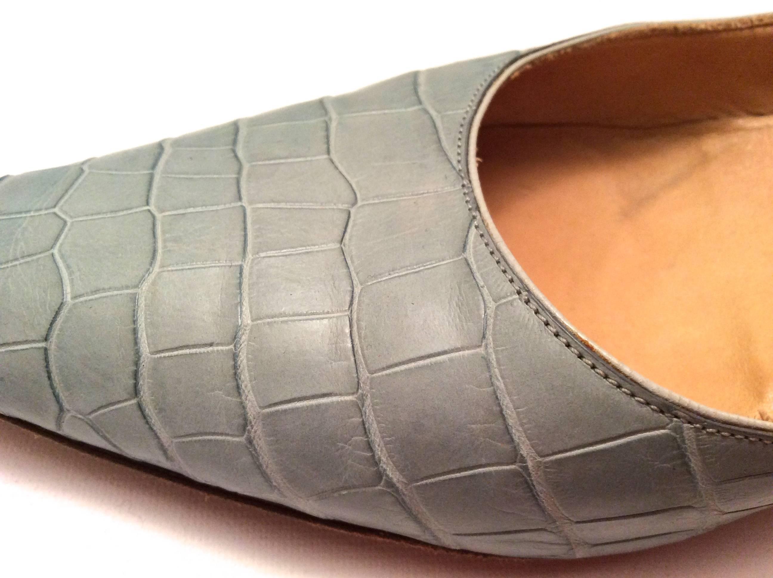 These Asprey Blue Alligator heels are a size 38. They are a matte finish light  blue / indigo tone. They are crafted with gorgeous alligator skin by the craftsmen at Asprey. They are lightly used with light wear to the bottom of the shoe. The