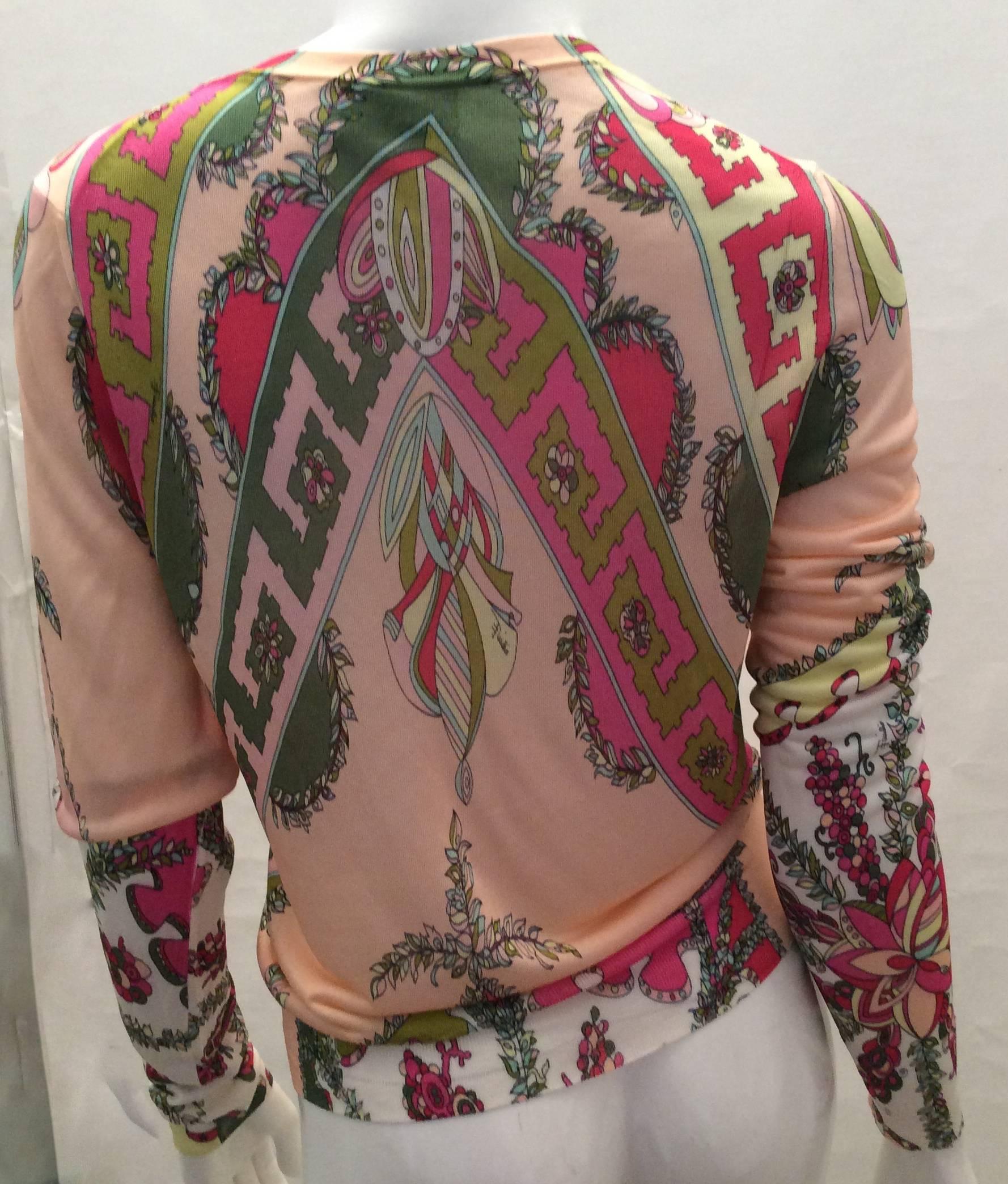 This set is absolutely magnificent and truly unique. It encompasses a new Emilio Pucci button down cardigan with a matching silk scarf. The cardigan is in beautiful shades of pink, peach and greens in a typical Emilio Pucci beautiful design. The