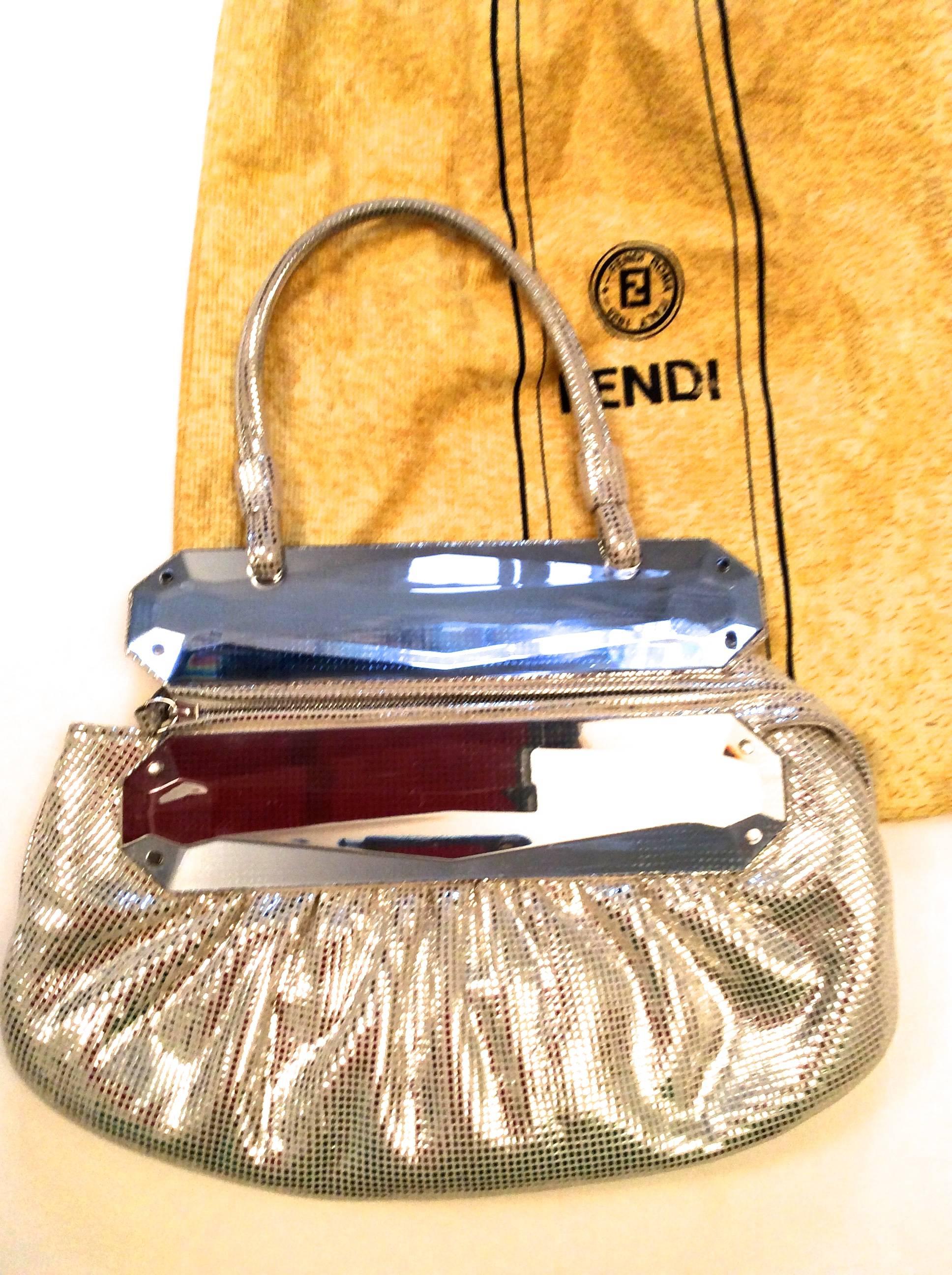 You are looking at a beautiful Fendi evening bag which measures 8.5 inches high and 11 inches wide. The front of the bag has a zipper enclosure which is 9 inches and a leather tab that snaps on the back. The drop of the strap is 13.5 inches. It is