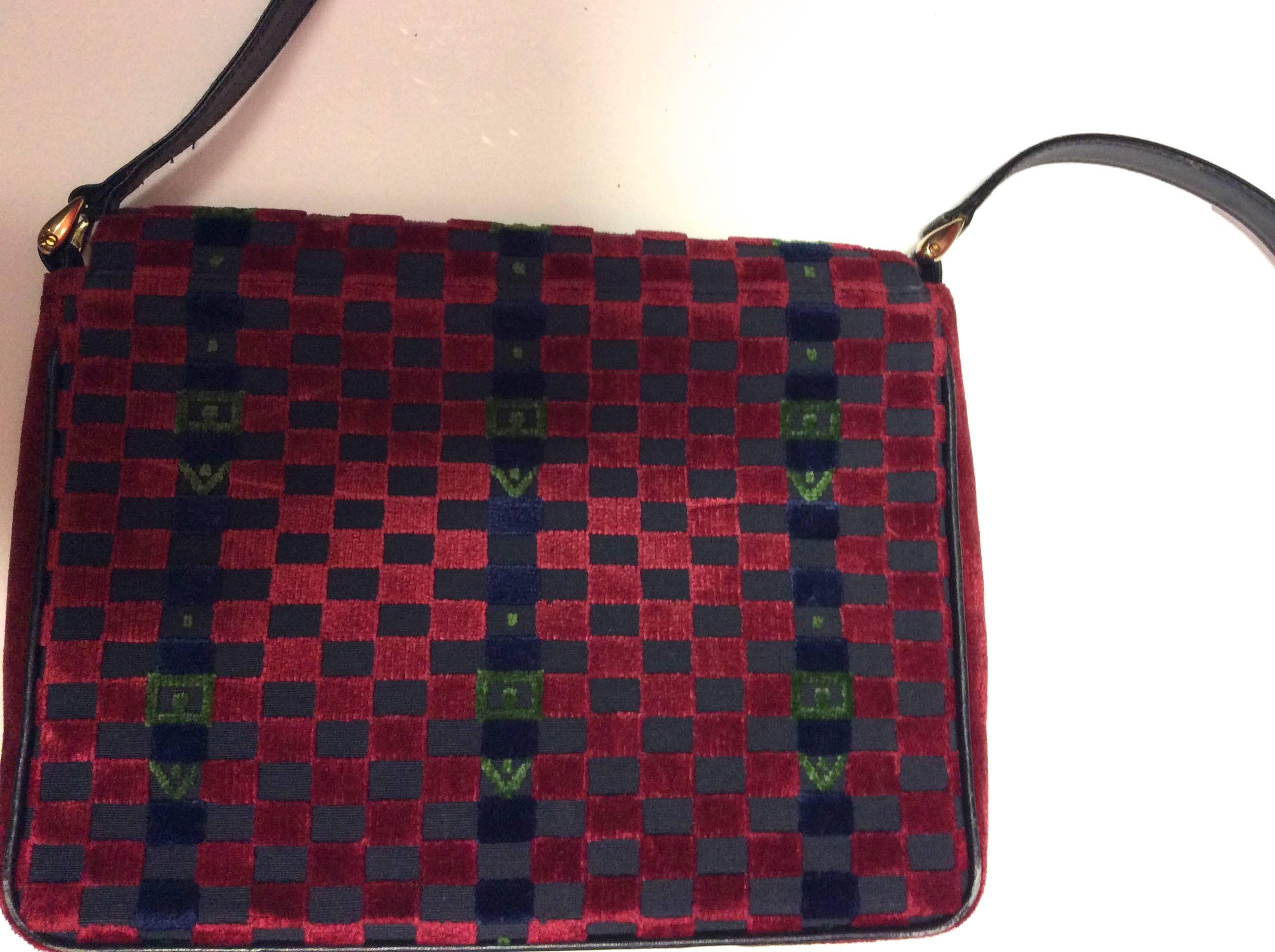 Presented here is a gorgeous vintage Roberta diCamerino purse. The purse is from the late 1970's. The purse has a checkered pattern on the exterior made of velvet. The pattern consists of red, blue, and green checks across each side of the bag. The