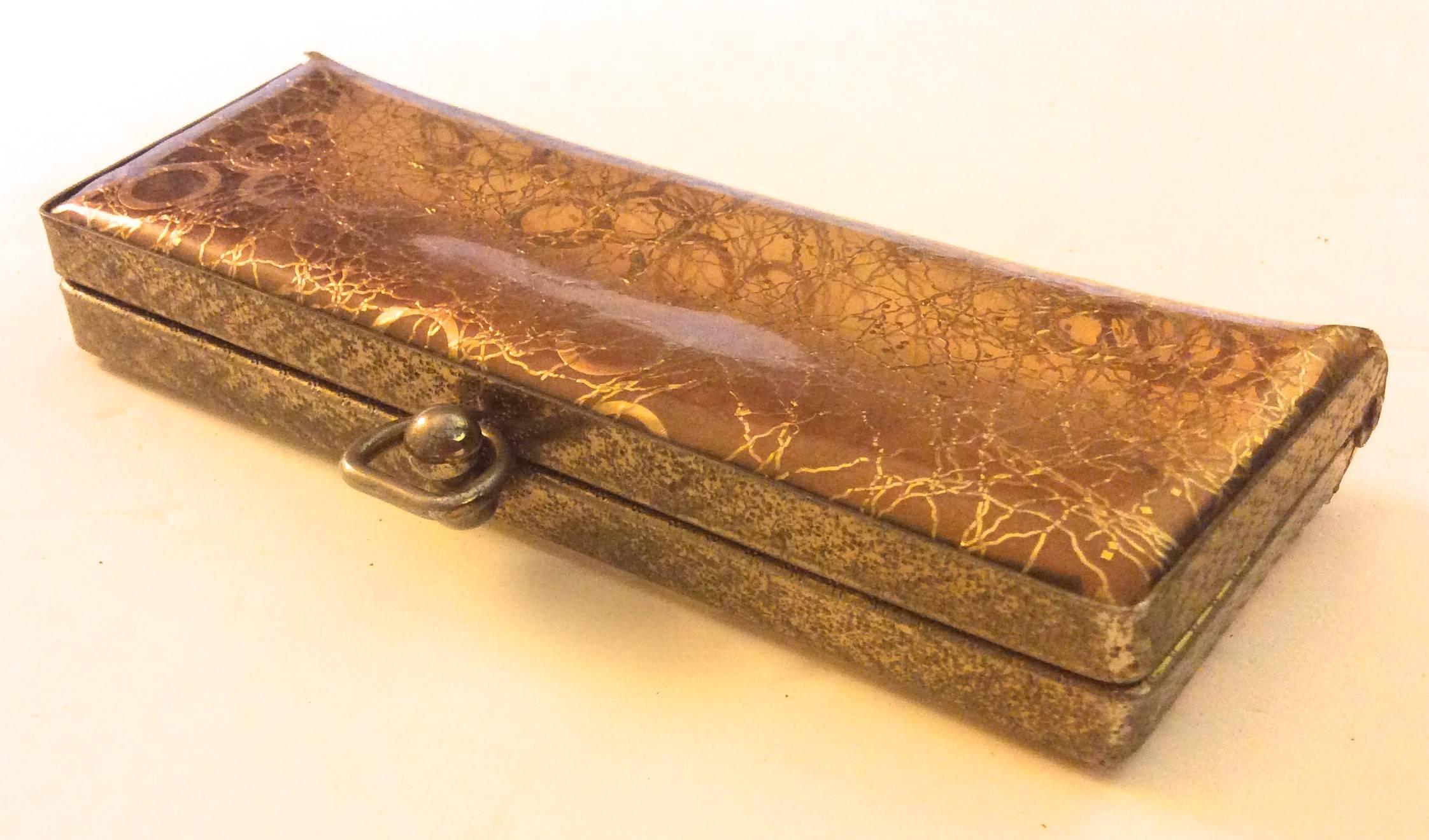 This vintage eyeglasses case is a stunning design made of clear and gold tone plastic. The case is lined in gold tone metal around the edge of the eyeglasses case. The case is in very good condition with some light scuffs around the exterior of the
