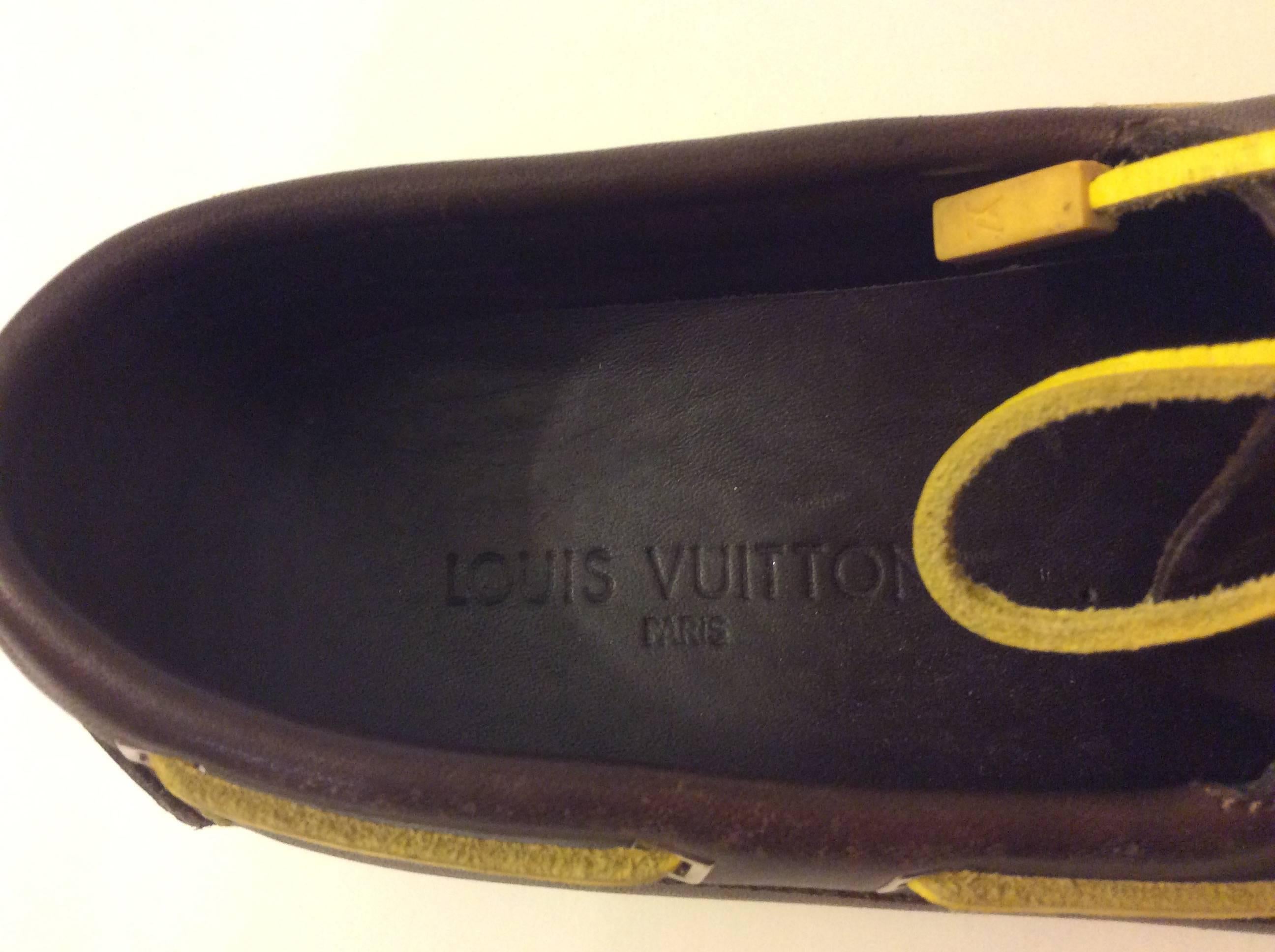 This pair of Louis Vuitton Docksiders were a special release for the Louis Vuitton Cup. They are a size 37.5 and are a chocolate brown with yellow laces. They have been worn for a fittings, but are in near mint condition. The shoes are 10 inches
