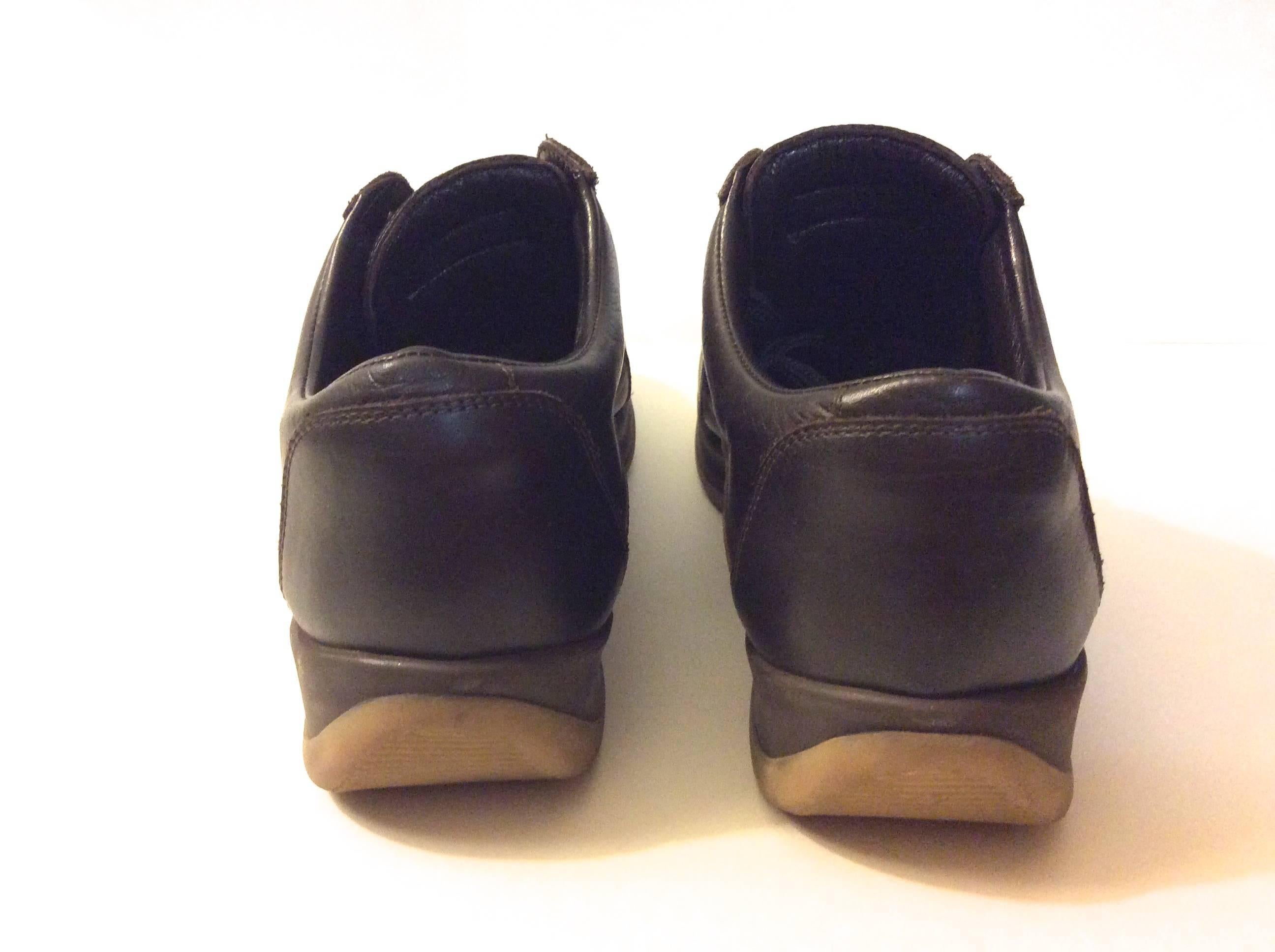 You are looking at a beautiful pair of ladies Louis Vuitton brown leather shoes with rubber sole. Size is equivalent to a size 7.5 / 8 despite sizing label stating 39.5. They have brown laces. The shoes are 10 inches long. The back of the sole turns