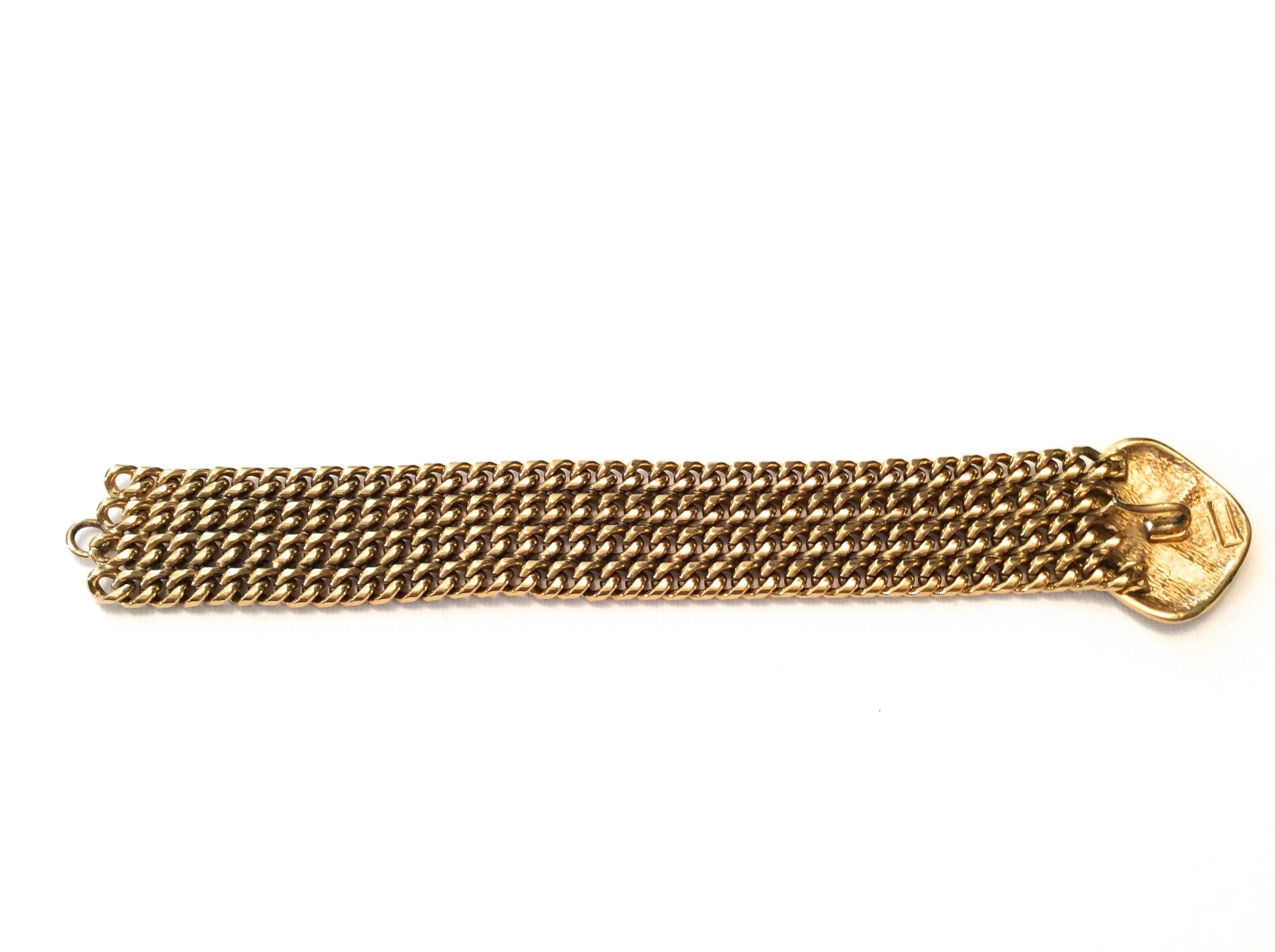 Presented here is a gold tone bracelet from Chanel. The bracelet is vintage and from the 1980's. The bracelet has a beautifully woven chain band and has a criss crossed diamond shape on the exterior of the band on the top. The band is very