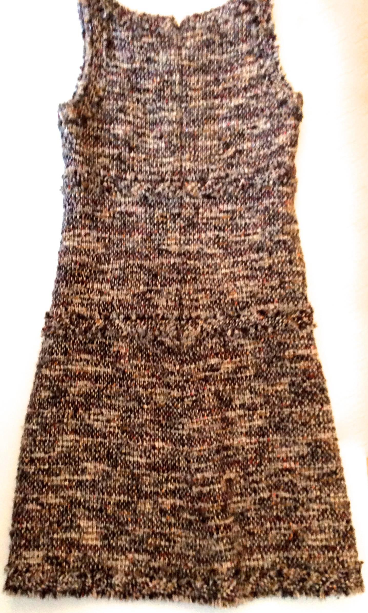 This beautiful sleevless Chanel dress is from the fall of 2007. It is in excellent condition with nearly no signs of use. The boucle fabric has gold threading throughout with beautiful shades of beige, rust, caramel, black, and gray. 

The dress can