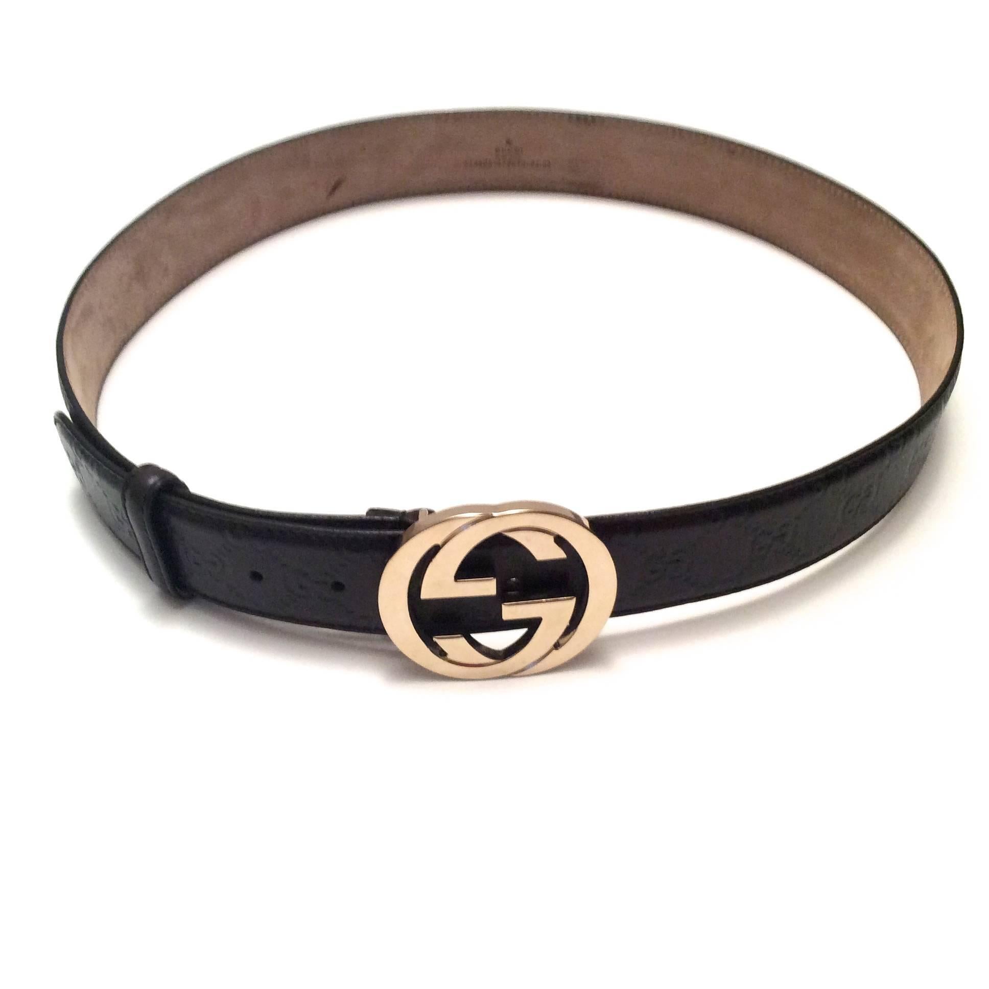 Presented here is a men's Gucci brown leather belt. This belt is a staple for every wardrobe. The belt is brown leather that is embossed with the classic Gucci insignia throughout the leather of the belt. The buckle is the classic interlocking 'G'
