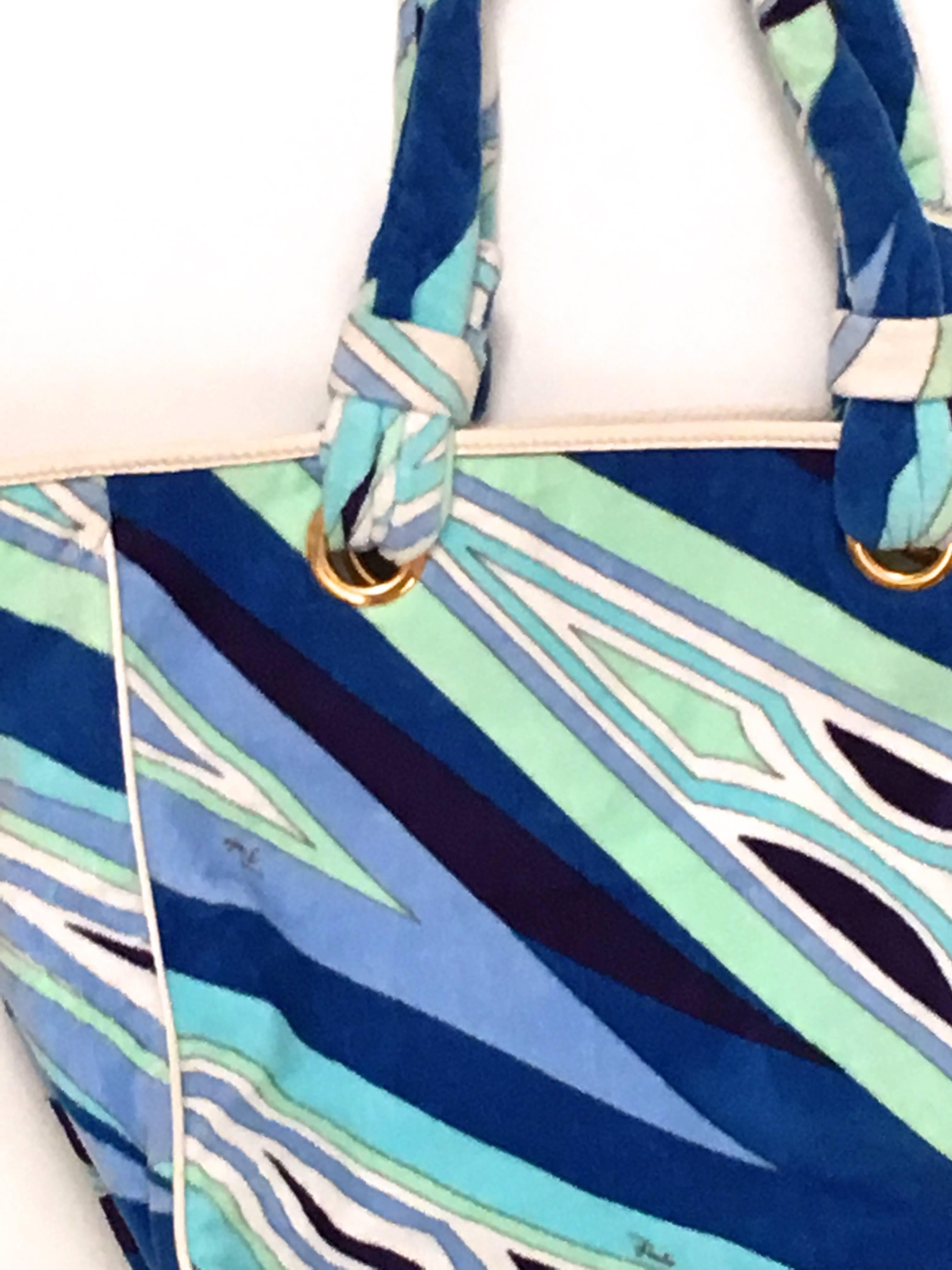 Presented here is a fantastic Emilio Pucci beach bag. The bag is made entirely of soft cotton terry cloth in a gorgeous array of geometrically patterned shapes of varying shades of light blues, dark blues, indigo, and shades of white. The bag is