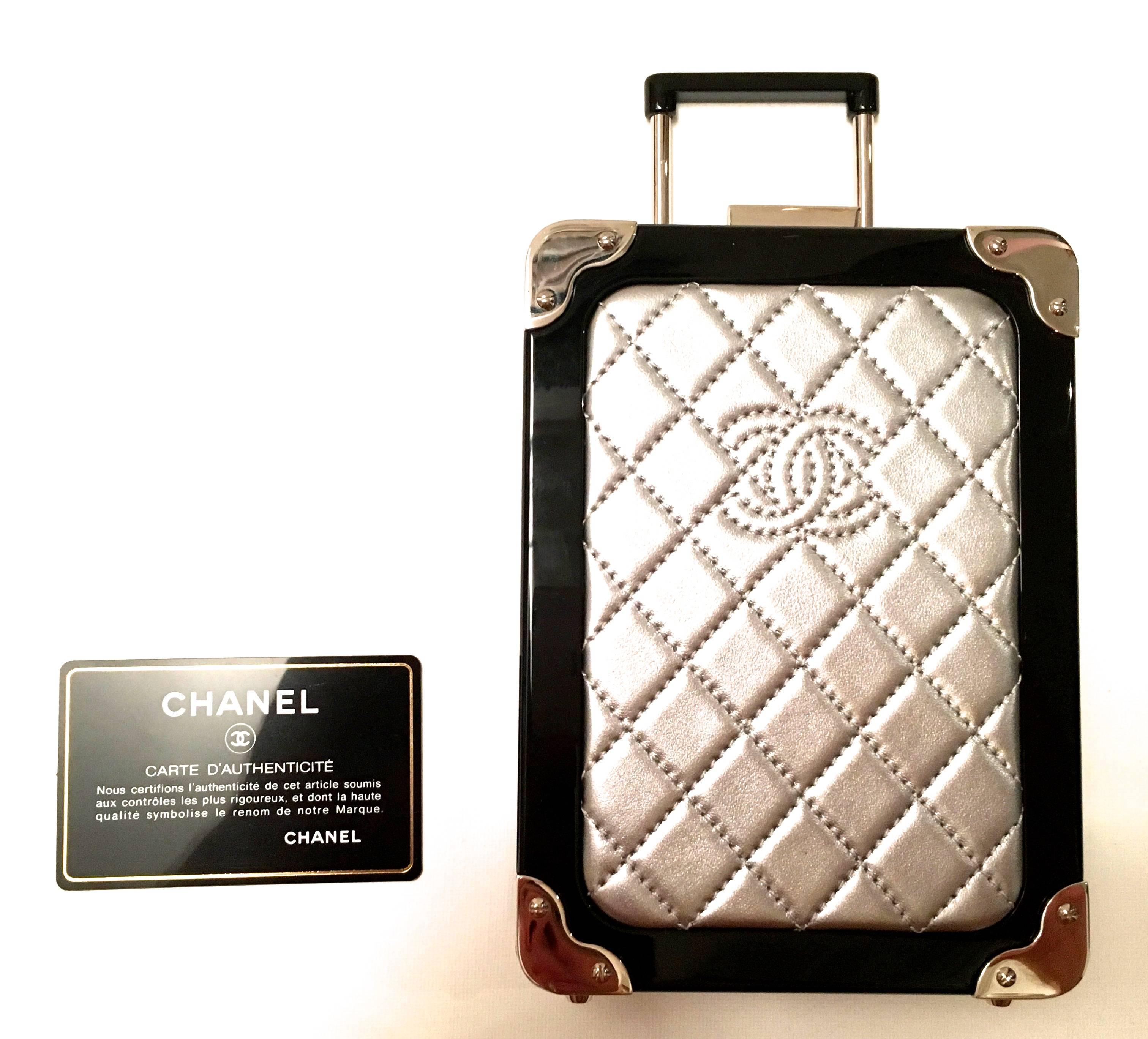 Presented here is an absolutely stunning runway purse from Chanel. Theclutch/purse is a mini version of a carry-on bag. There is a small retractable handle and small wheels just like a normal full-size carry-on piece of luggage. There is a shoulder