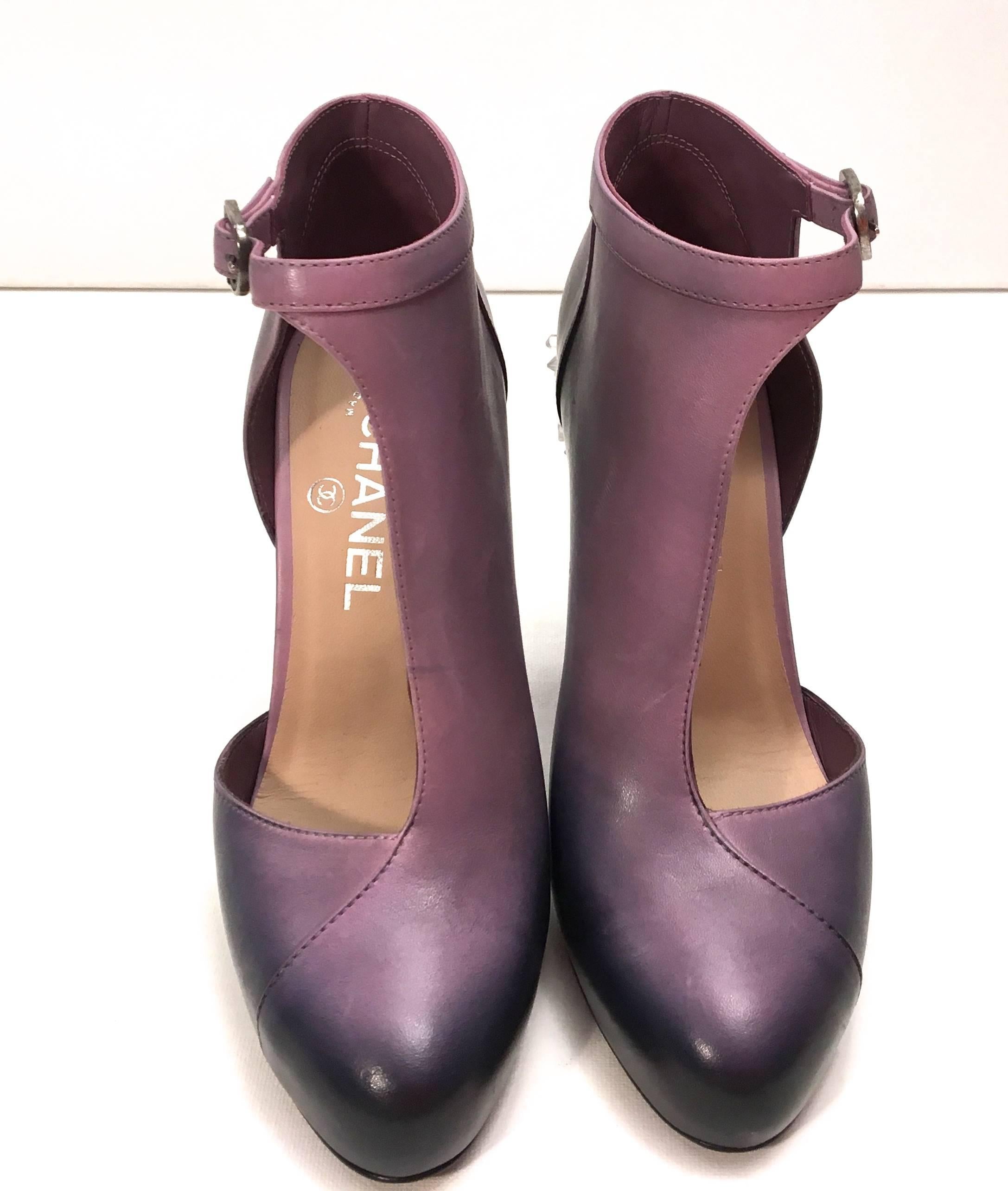 Chanel short runway boots. The shoes are a size 38 and run slightly small. They are a gradient of purple and black with half of the foot revealed. Closed toe. They have a purple lucite heel that looks like a cluster of ice in both purple and clear