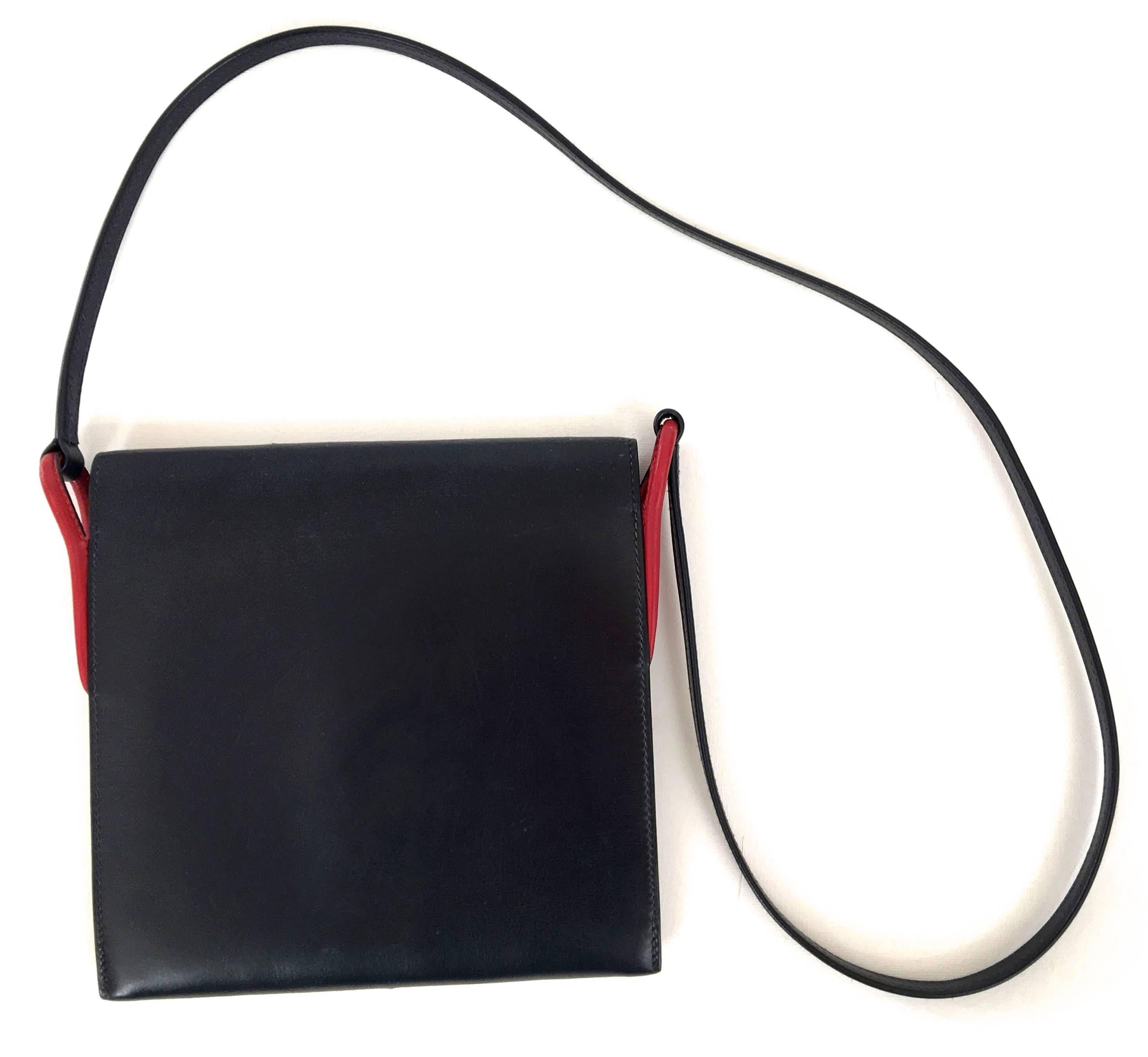 Presented here is an Hermes Purse from the 1960’s. The purse was referred to as the ‘Flo’ bag and has been fully restored to near perfect condition by the artisans at Hermes. The bag is a navy blue. There is a red cord trim on the sides and front