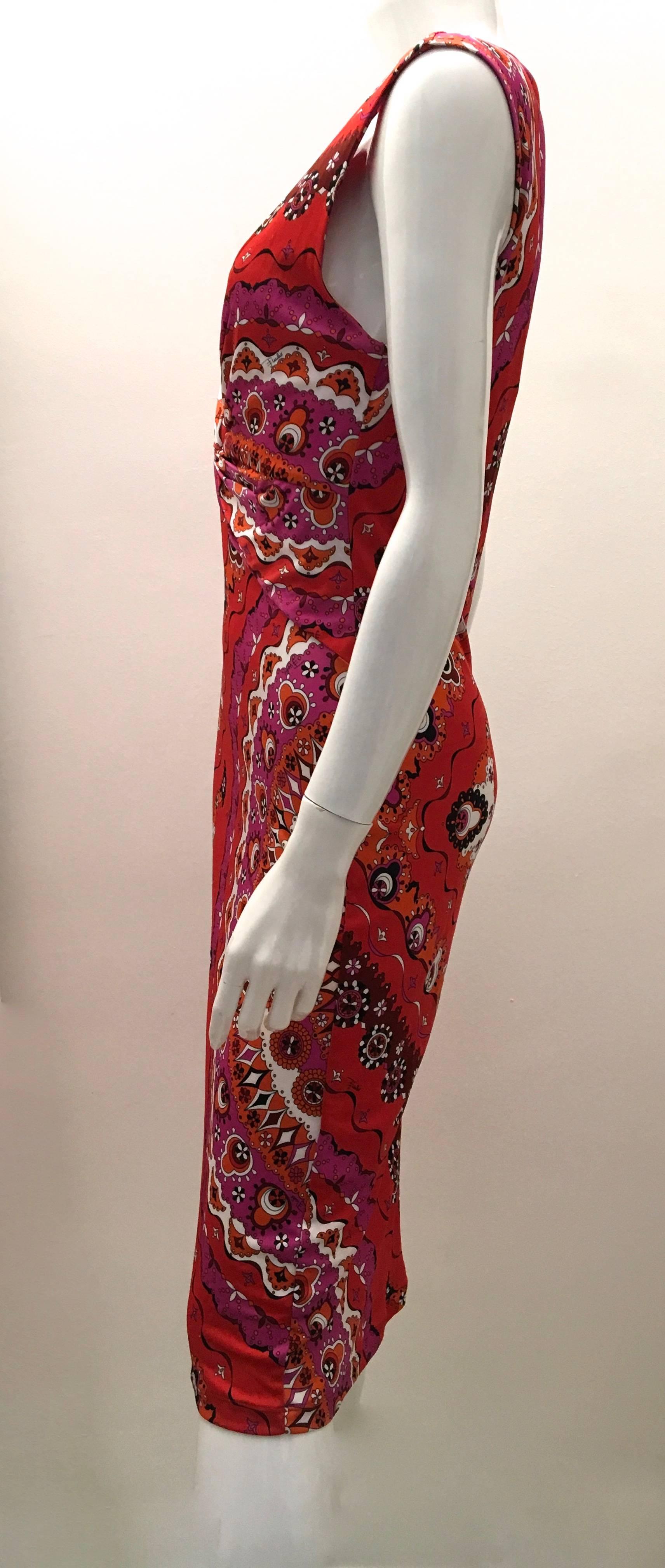 Presented here is a magnificent dress from Emilio Pucci. The garment is new and has only been used for fittings. The dress is a size 44 Italian. The dress is patterned in a design comprised of red, magenta, dark orange, white and black. The dress is