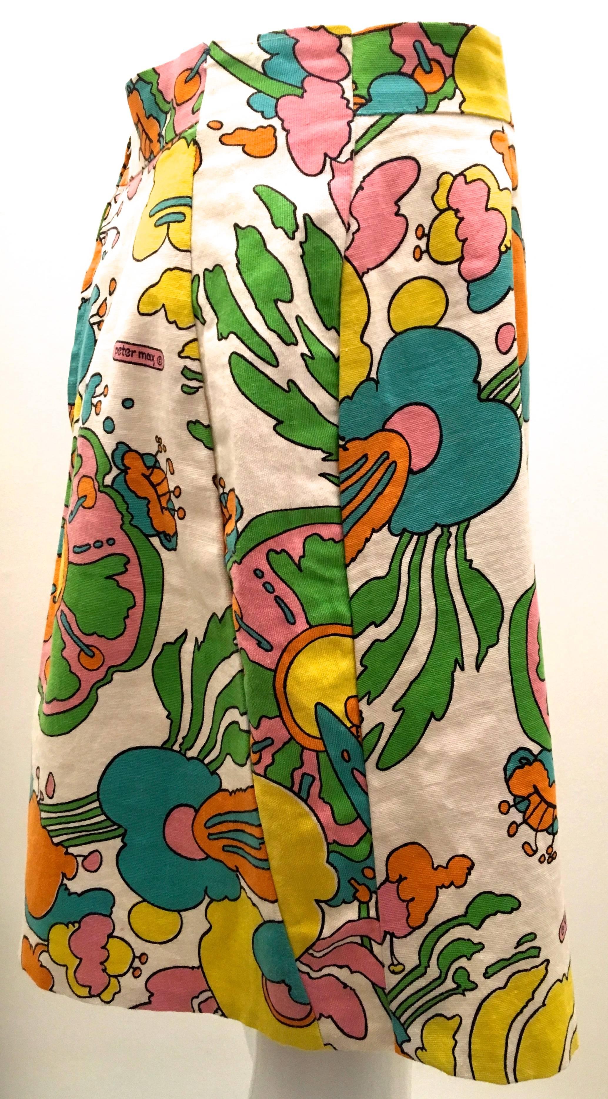 Presented here is a beautiful skirt from the late 1960’s / early 1970’s. The iconic Peter Max vibrant fabric is a fabulous example of this era. Peter Max’s art was influential throughout this era in the realm of the psychedelic movement and culture