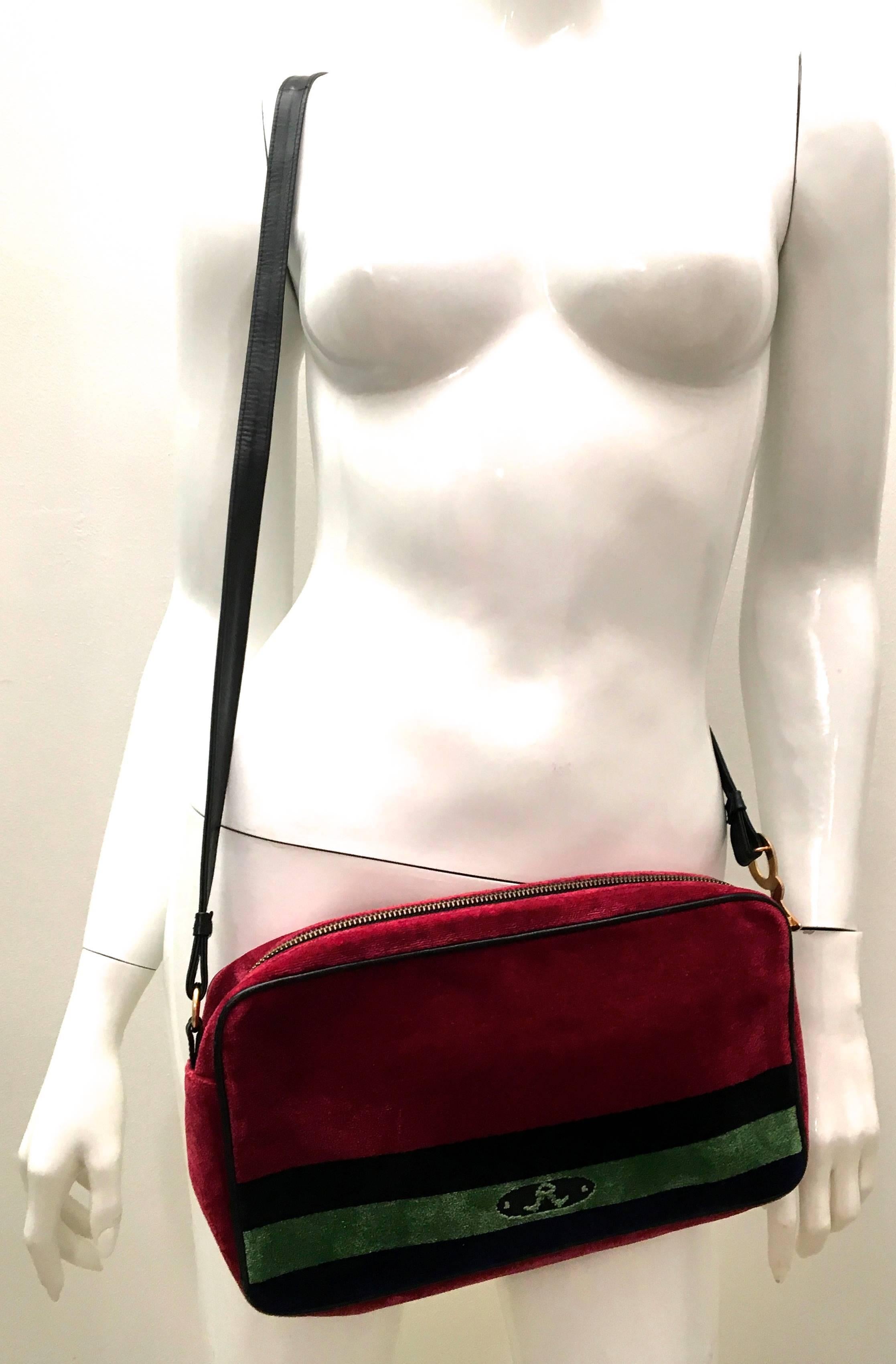 Presented here is a beautiful bag from Roberta di Camerino. The bag is comprised of a gorgeous bag that has burgundy, black, green and blue soft velvety fabric on the exterior. There is a gold tone metal zipper on the purse. There is an iconic gold