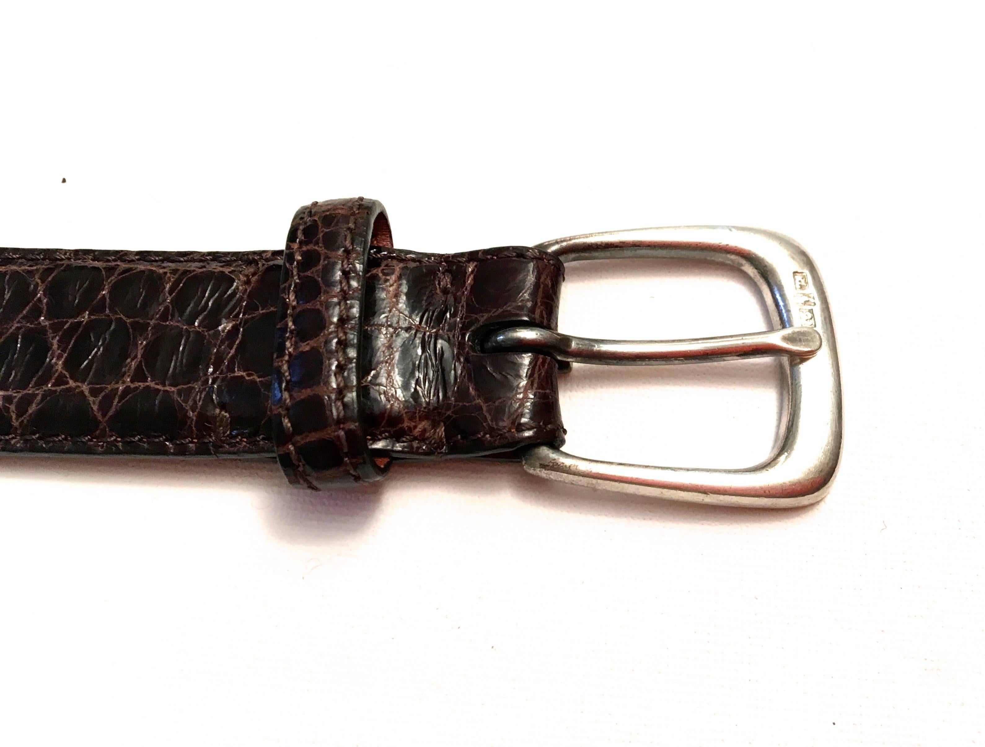 Presented here is a beautiful belt from Ralph Lauren. The belt is made from dark brown alligator and has a gorgeously crafted sterling silver buckle. The belt is 44 inches long and 1.2 inches wide. The buckle is 1.5 inches long and 1.5 inches wide.
