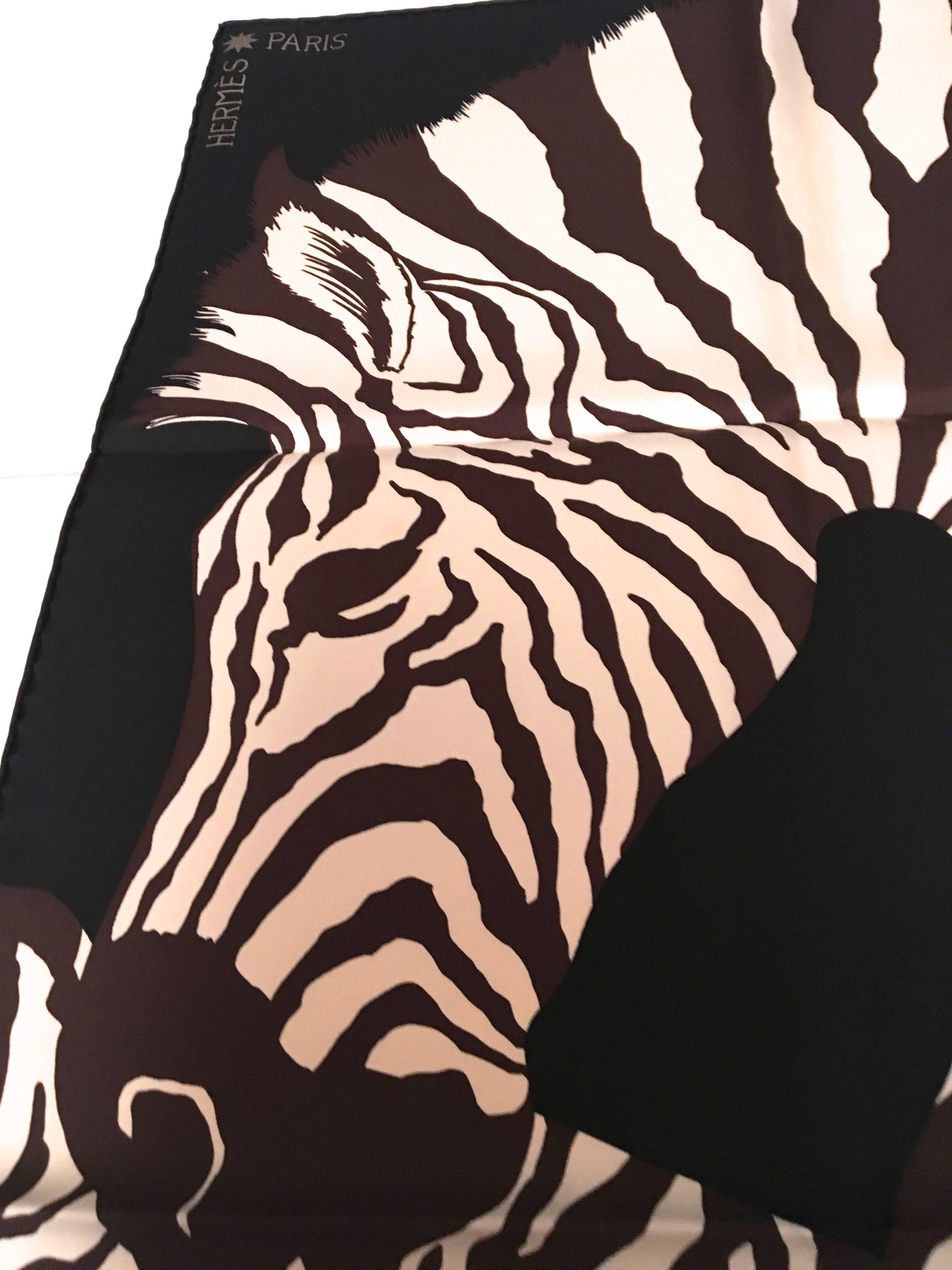 Presented here is a rare Hermes zebra pegasus scarf. The design is comprised of colors of black, brown, white and golden tones throughout the coloring of the scarf. The scarf measures 35 inches by 35 inches. The scarf is signed by Hermes in the