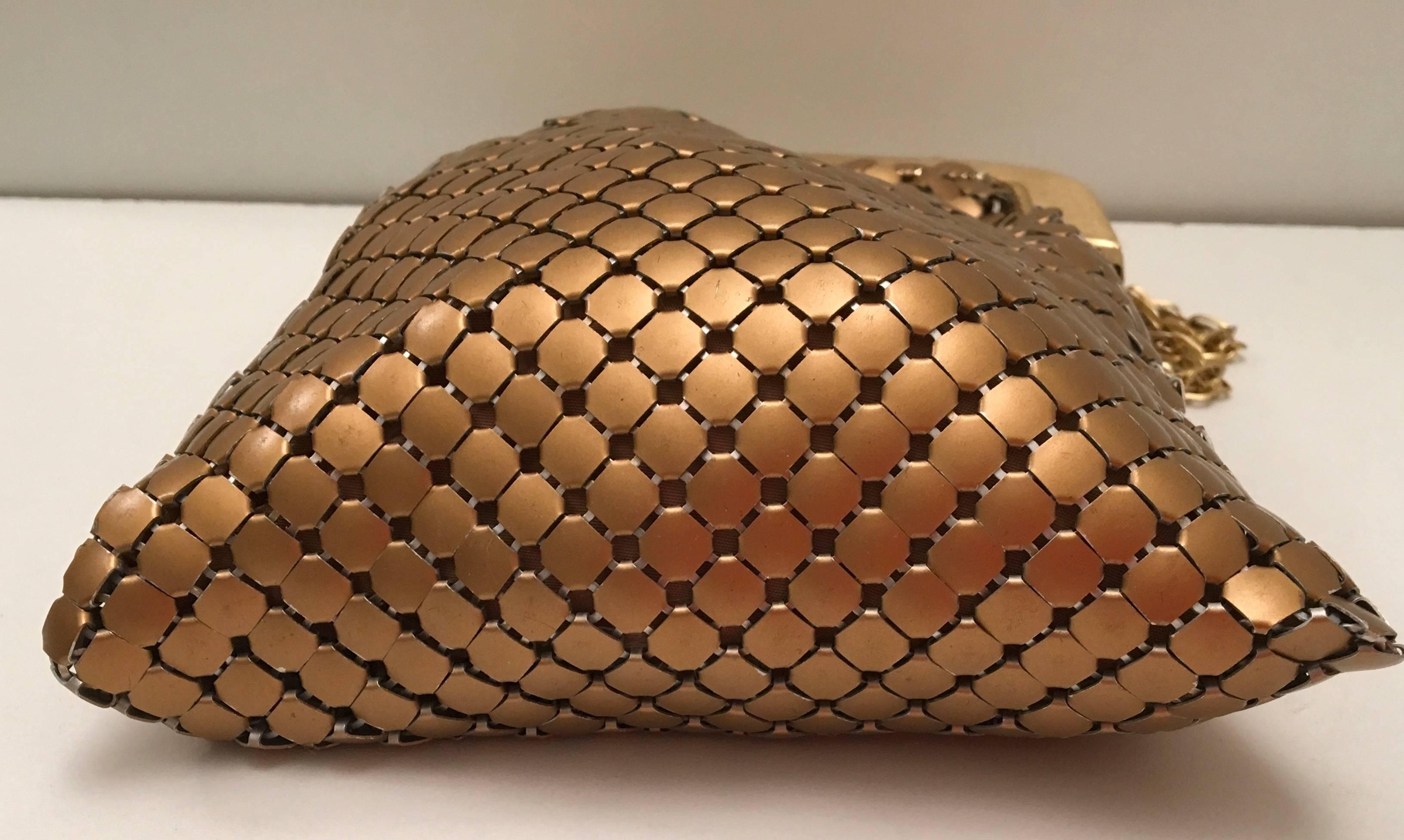 Presented here is a beautiful vintage Whiting and Davis gold mesh evening bag from the 1970's. The purse is comprised of a beautiful matte finish gold tone metal coloring on the exterior of the bag. The gold tone metal chain is 30 inches long. The
