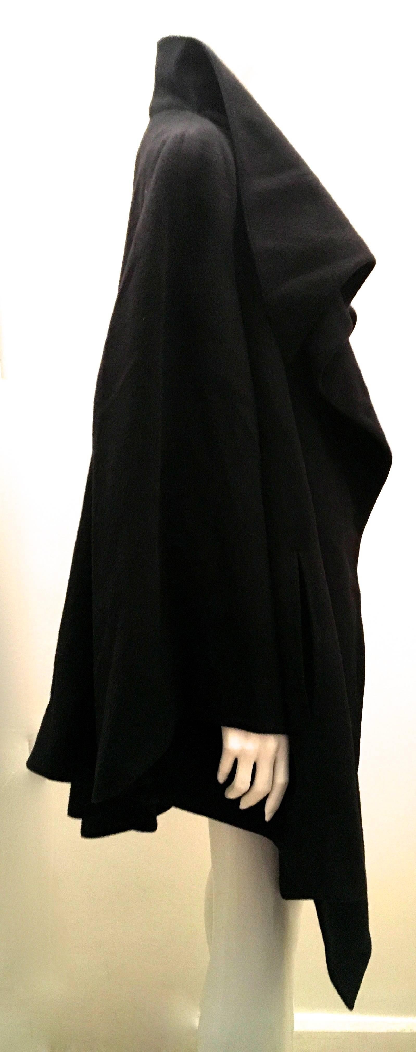 Presented here is a fabulous Claude Montana swing coat. The coat is from the 1990's and is in excellent condition. The coat is comprised of soft black wool throughout the exterior of the coat. The inside is completely lined with a black soft blend
