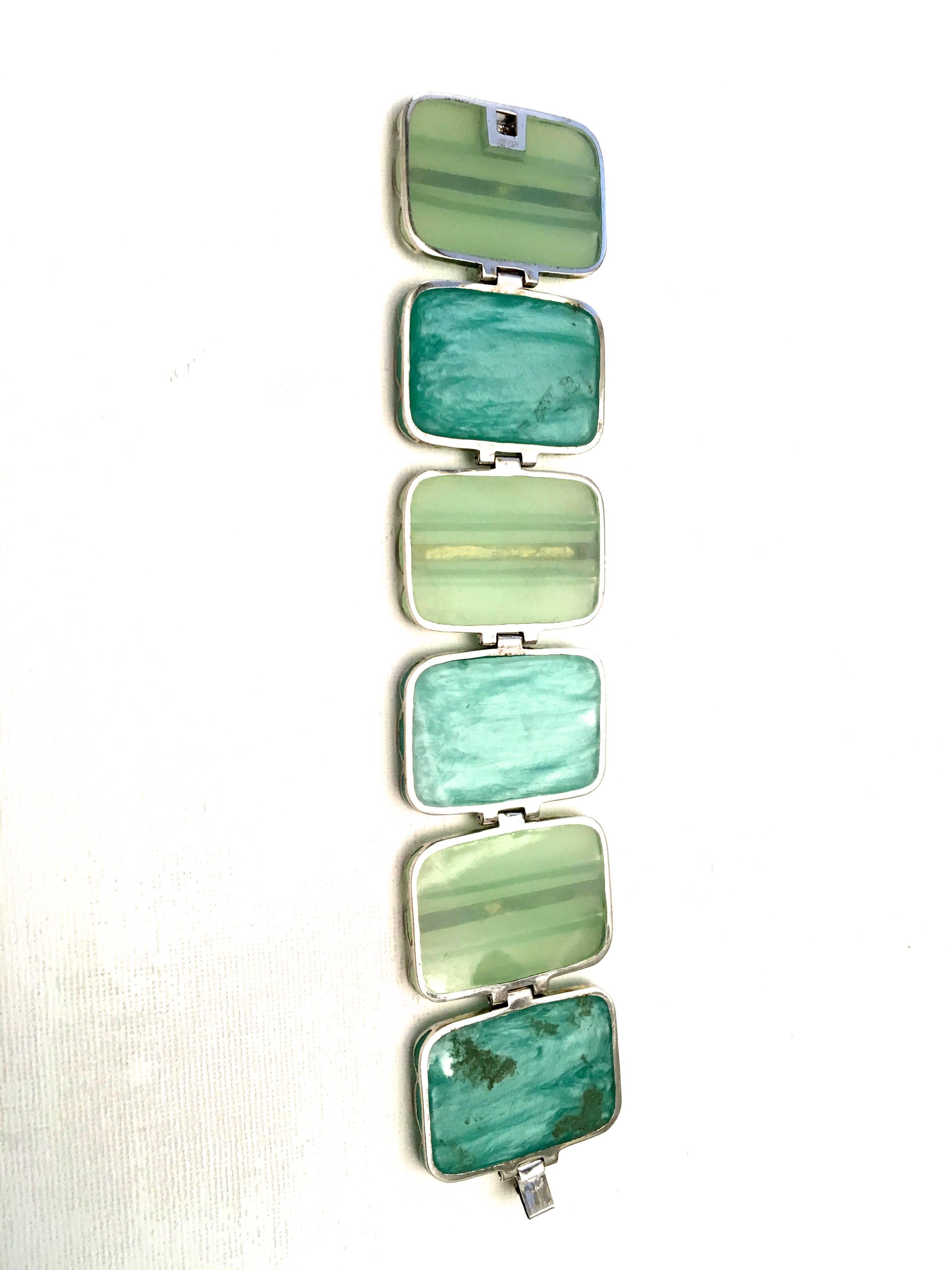 Presented here is an absolutely magnificent example of Miriam Salat. One of today's young fine jewelry designers. The bracelet consists of 6 rectangles in shades of light sea foam and billowy teal. Each is surrounded by a sterling casing with