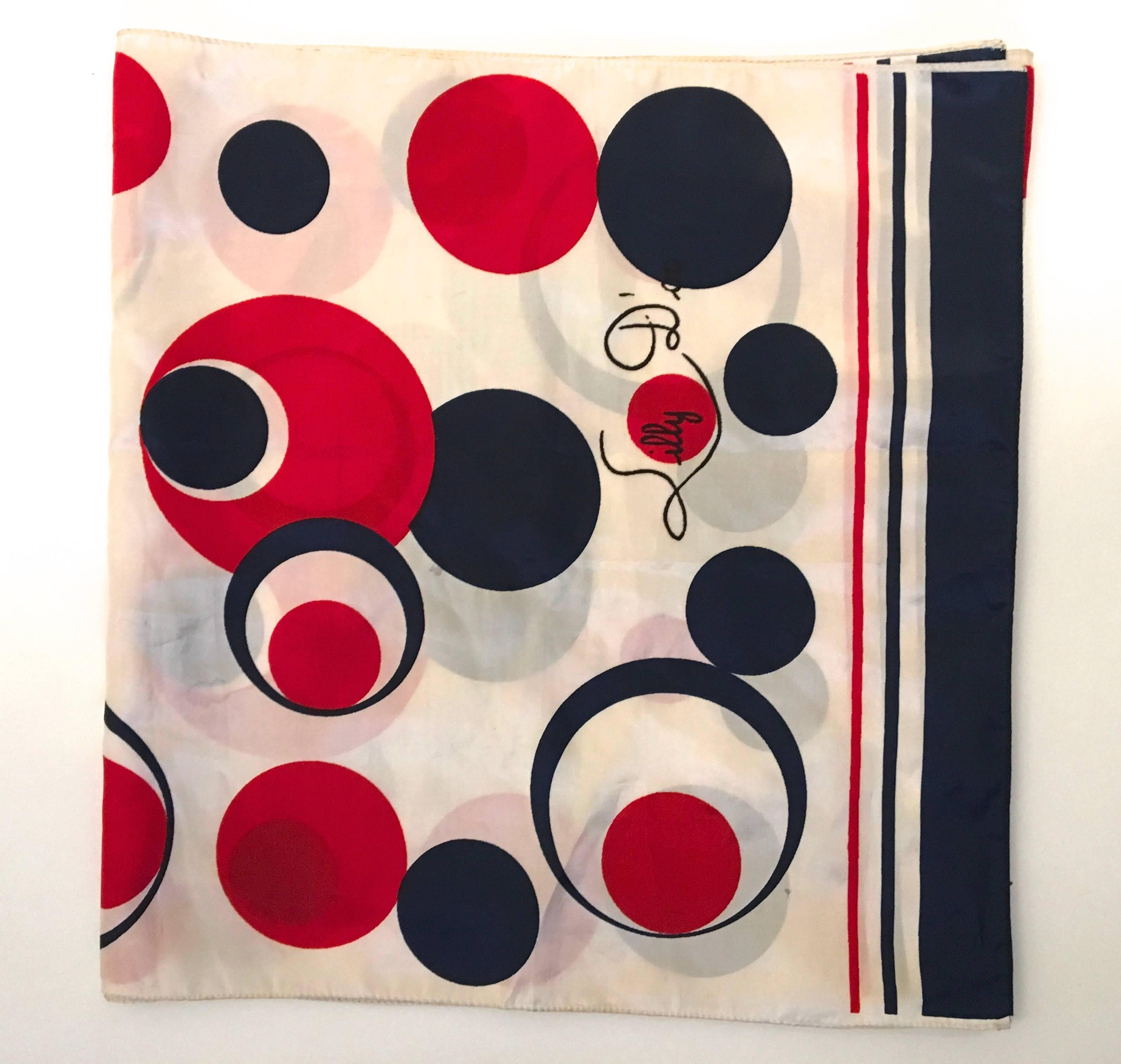 Presented here is a beautiful vintage scarf from Lilly D'or. This rare scarf is comprised of a series of mod-geometric circles. The scarf is from the 1960's. The circles are red and dark navy blue against a white backdrop. There is a red and blue