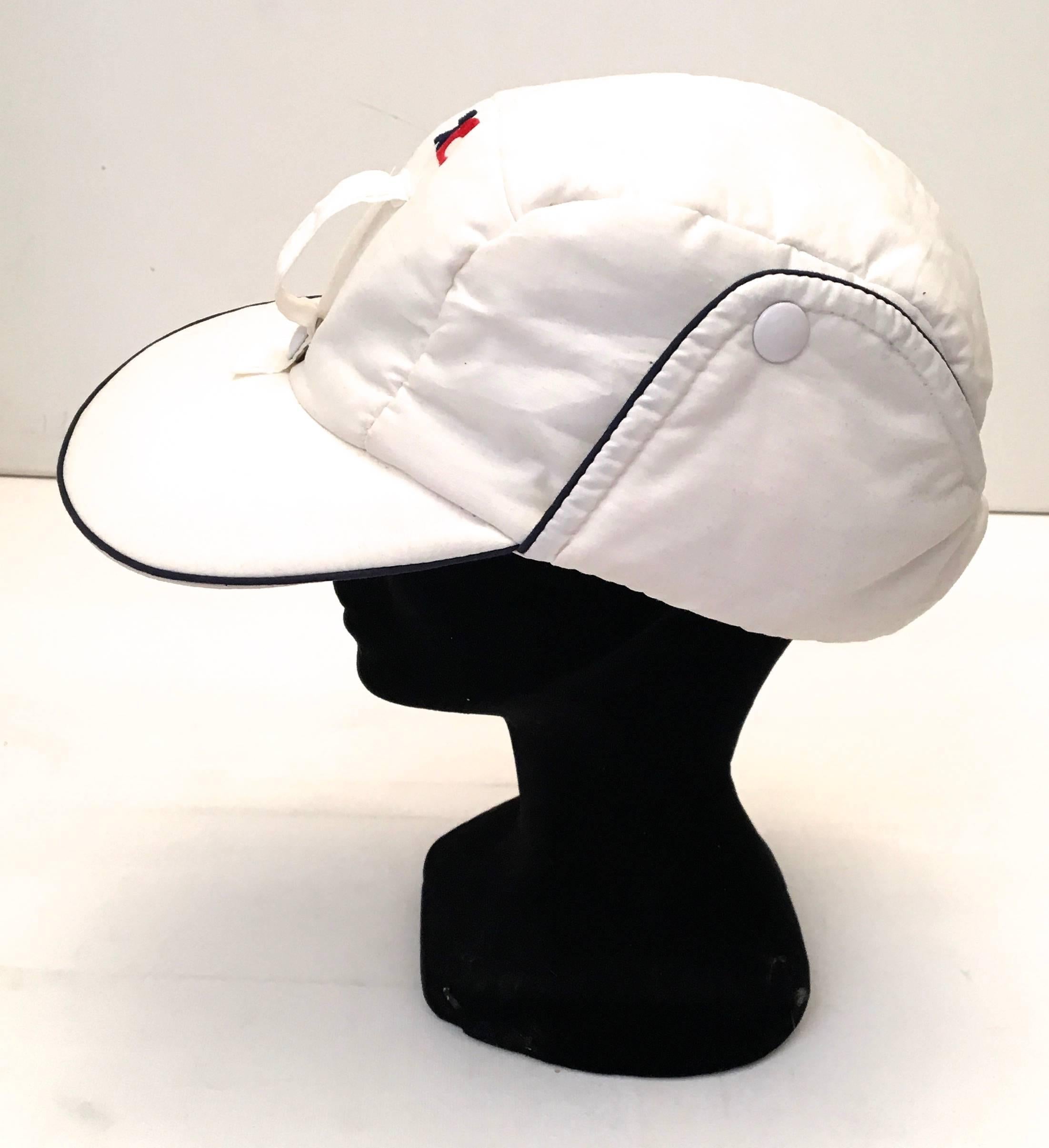 Presented here is a beautiful hat from Courreges. The white in the hat which is a blend of 30% nylon, 35% cotton and 30% polynosique feels like a typical ski cap hat. There are button snaps and velcro that allow for a few different styles of wear.